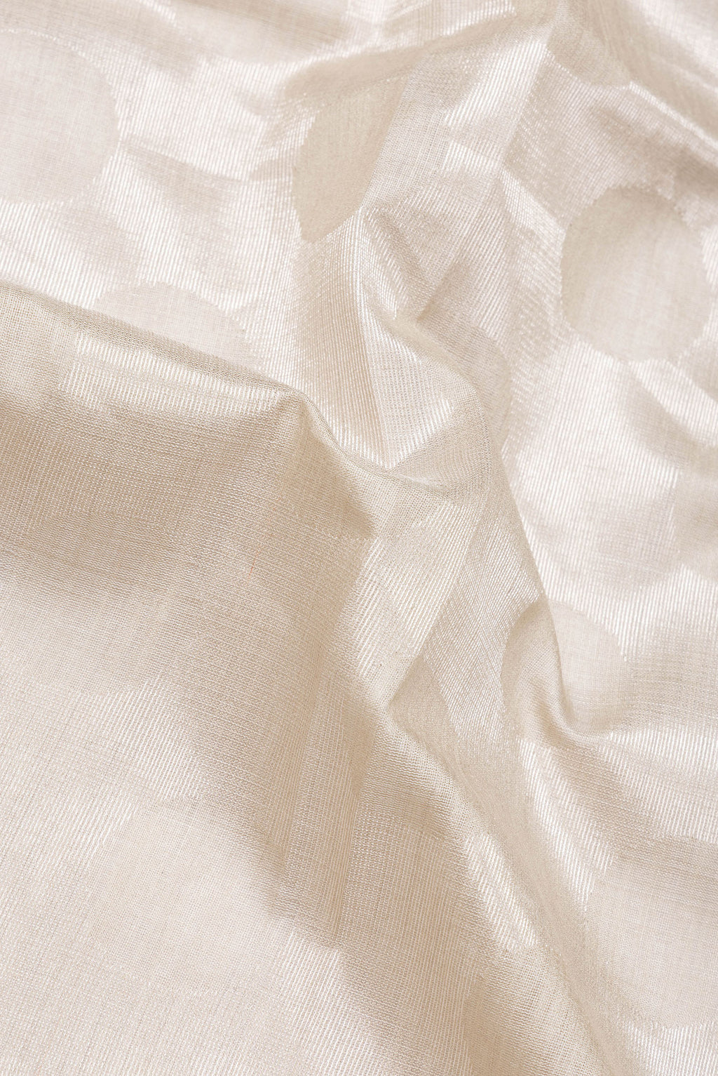 Close up of Beige Dual Tone Tussar Silk Saree with Zari Brocade on the body and Plain Border.  displaying folds