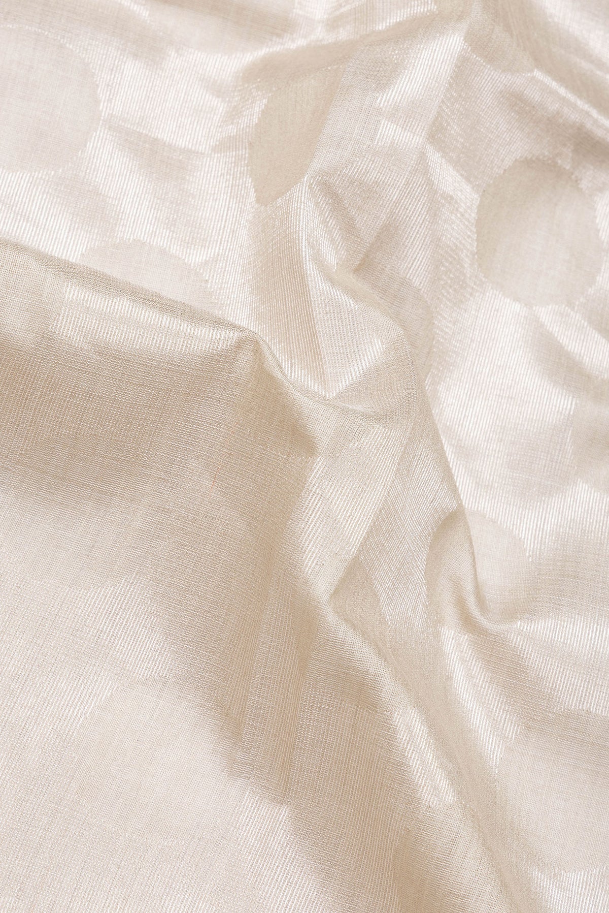 Close up of Beige Dual Tone Tussar Silk Saree with Zari Brocade on the body and Plain Border.  displaying folds