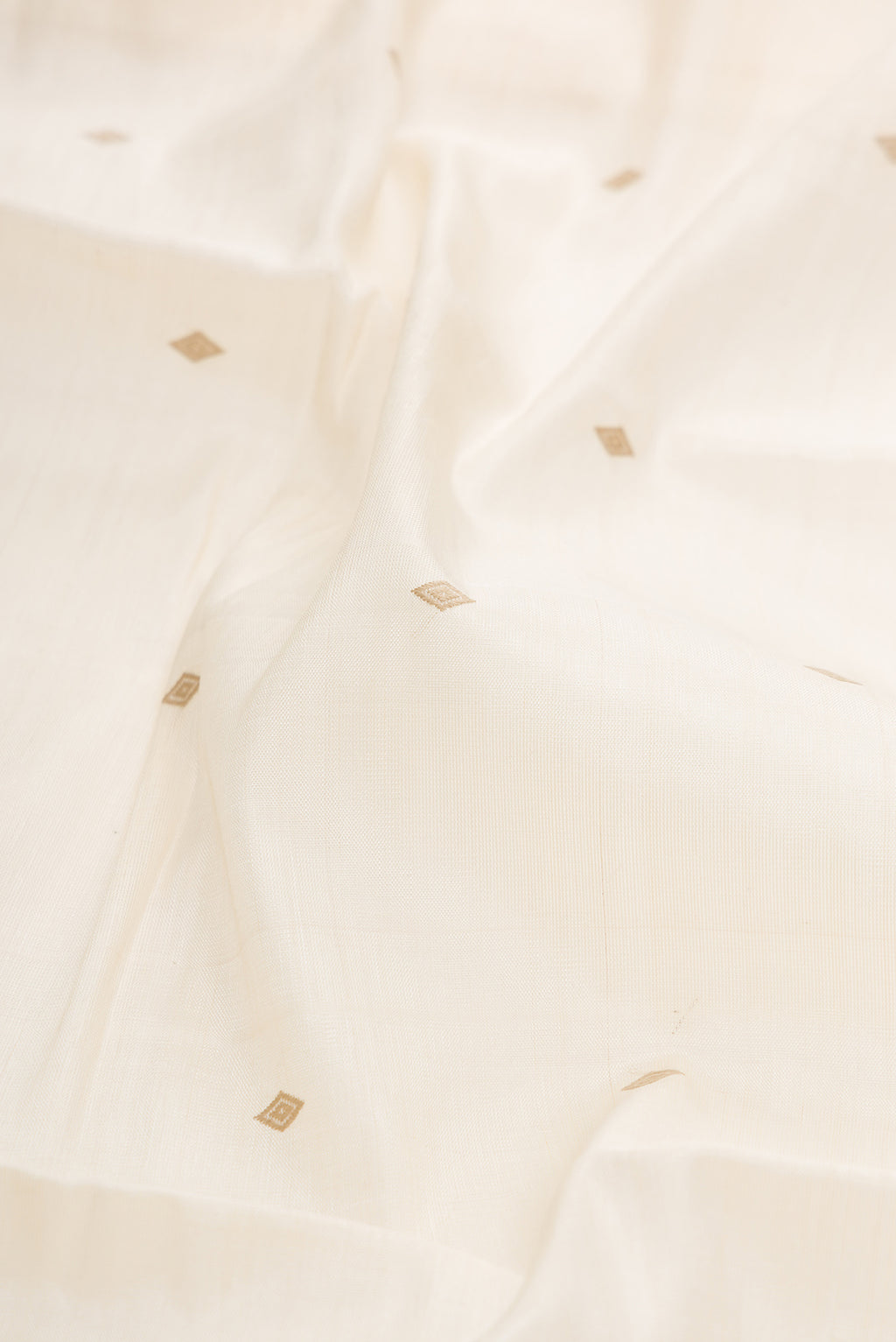 Close up of Sandal Dual Tone Tussar Silk Saree with Thread Butta on the body and Zari Border.  displaying folds