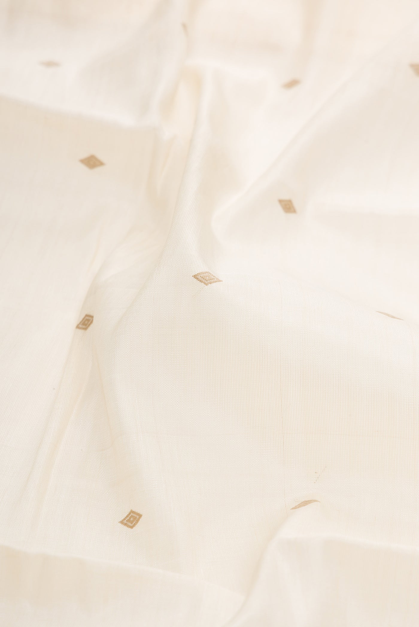Close up of Sandal Dual Tone Tussar Silk Saree with Thread Butta on the body and Zari Border.  displaying folds
