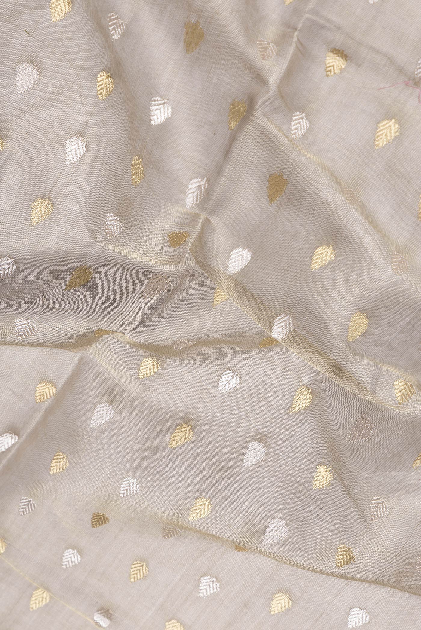 Close up of Mehandi Green Dual Tone Tussar Silk Saree with Zari Butta on the body and Thin Zari Line.  displaying folds