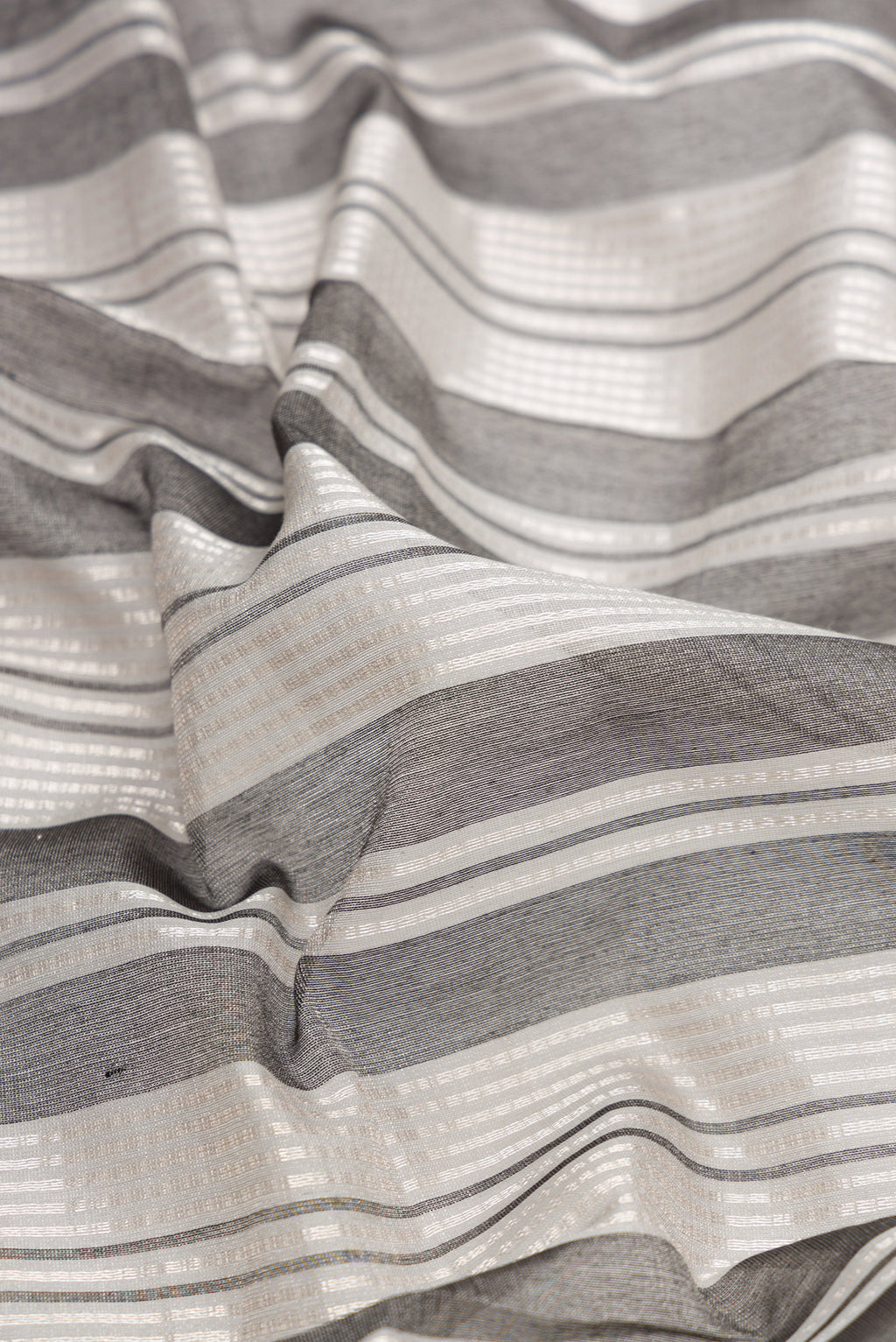 Close up of Grey Dual Tone Tussar Silk Saree with Stripes on the body and Without Border.  displaying folds