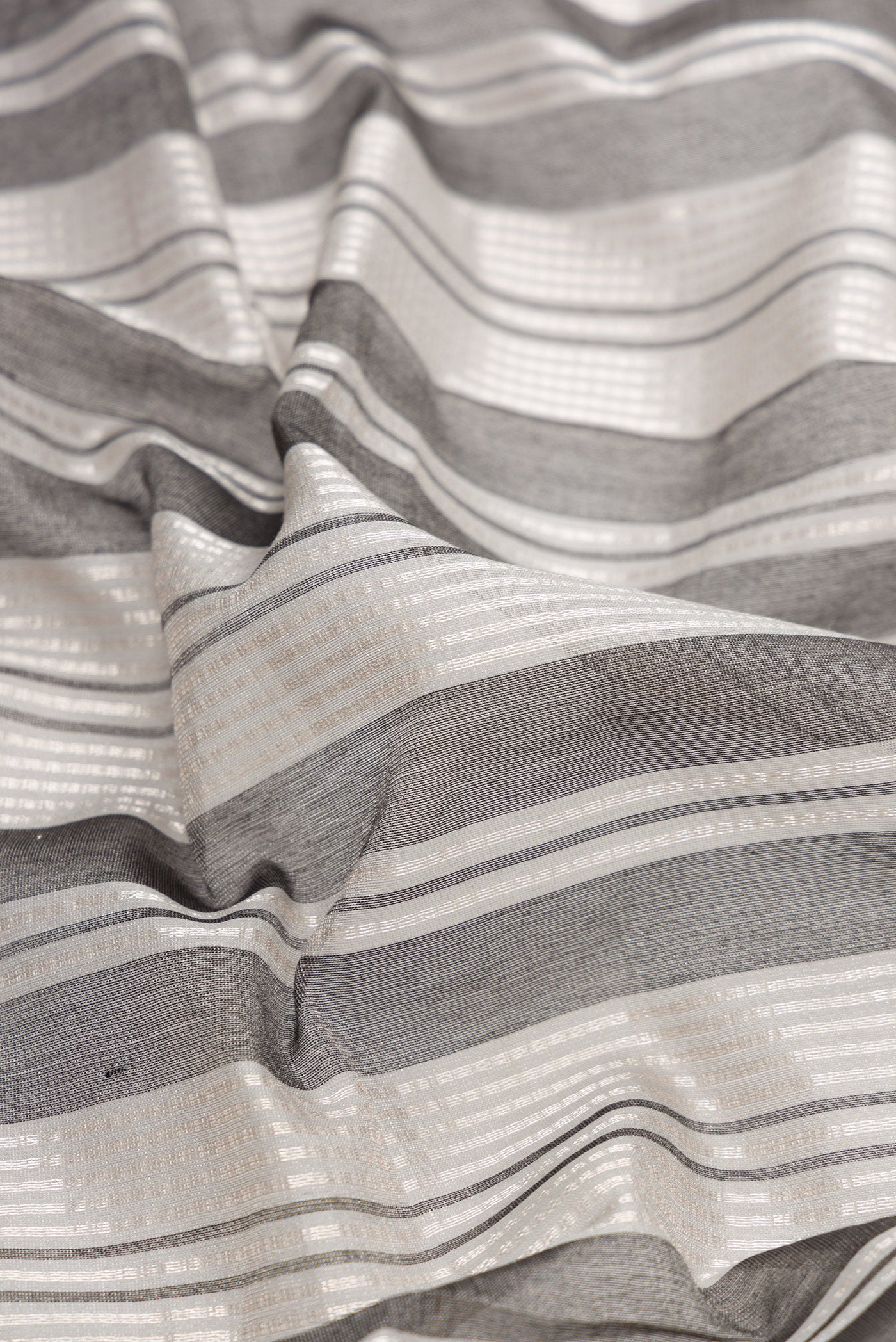 Close up of Grey Dual Tone Tussar Silk Saree with Stripes on the body and Without Border.  displaying folds