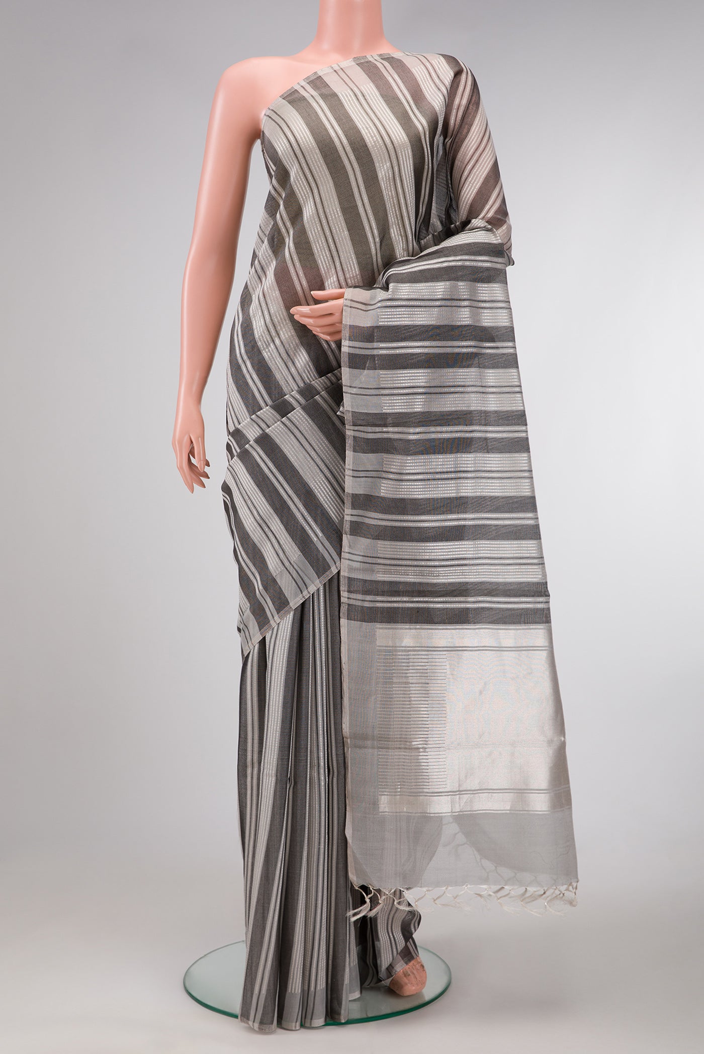 Grey Dual Tone Tussar Silk Saree with Stripes on the body and Without Border.  displayed on a mannequin