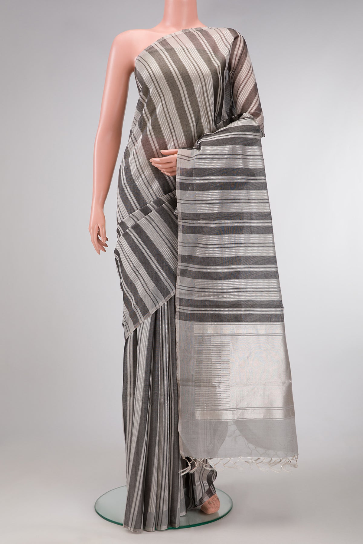 Grey Dual Tone Tussar Silk Saree with Stripes on the body and Without Border.  displayed on a mannequin