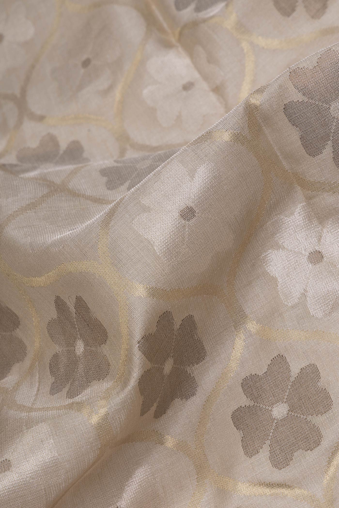 Close up of Beige Dual Tone Chanderi Silk Saree with Zari Brocade on the body and Without Border.  displaying folds