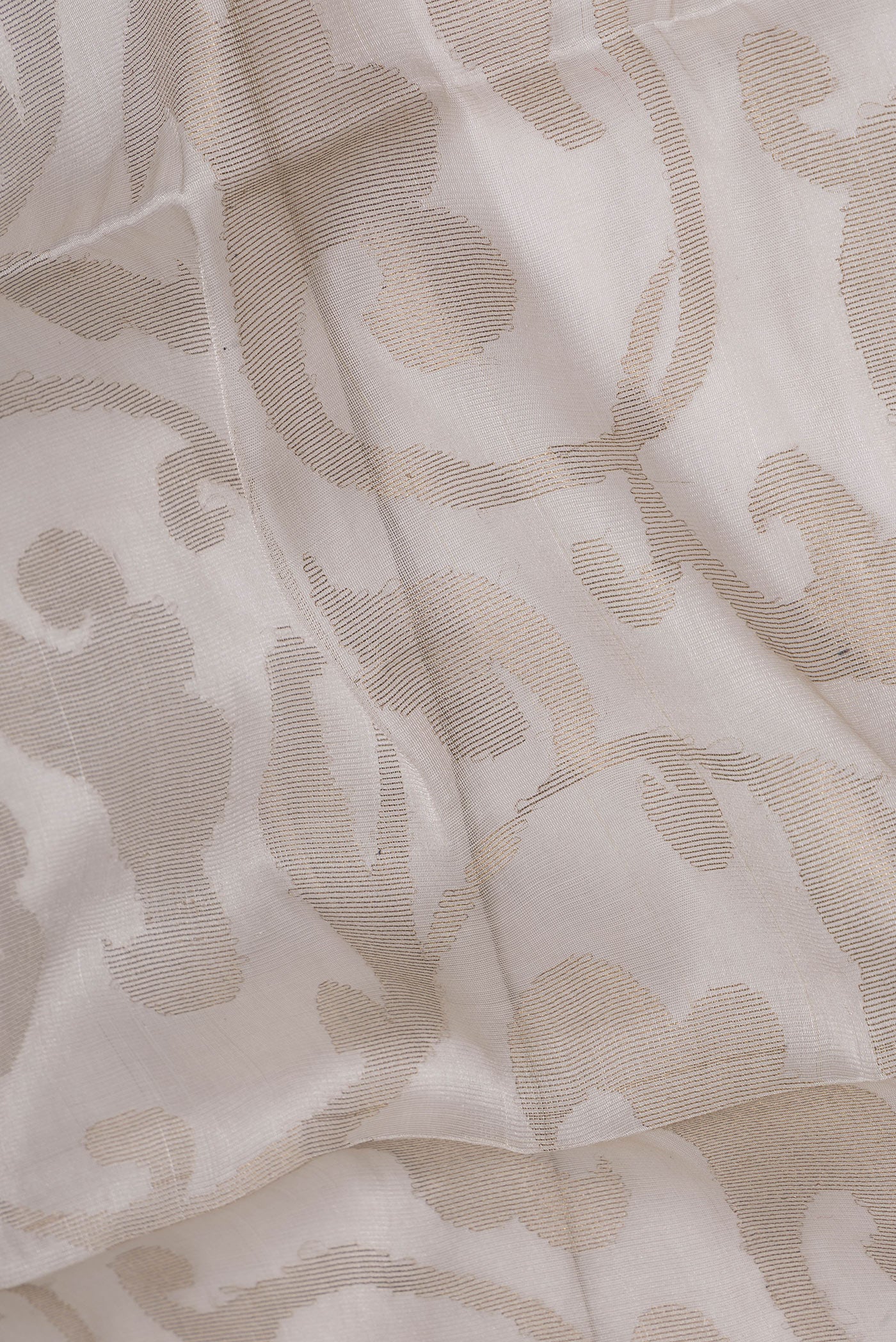 Close up of Beige Dual Tone Chanderi Silk Saree with Zari Brocade on the body and Zari Border.  displaying folds