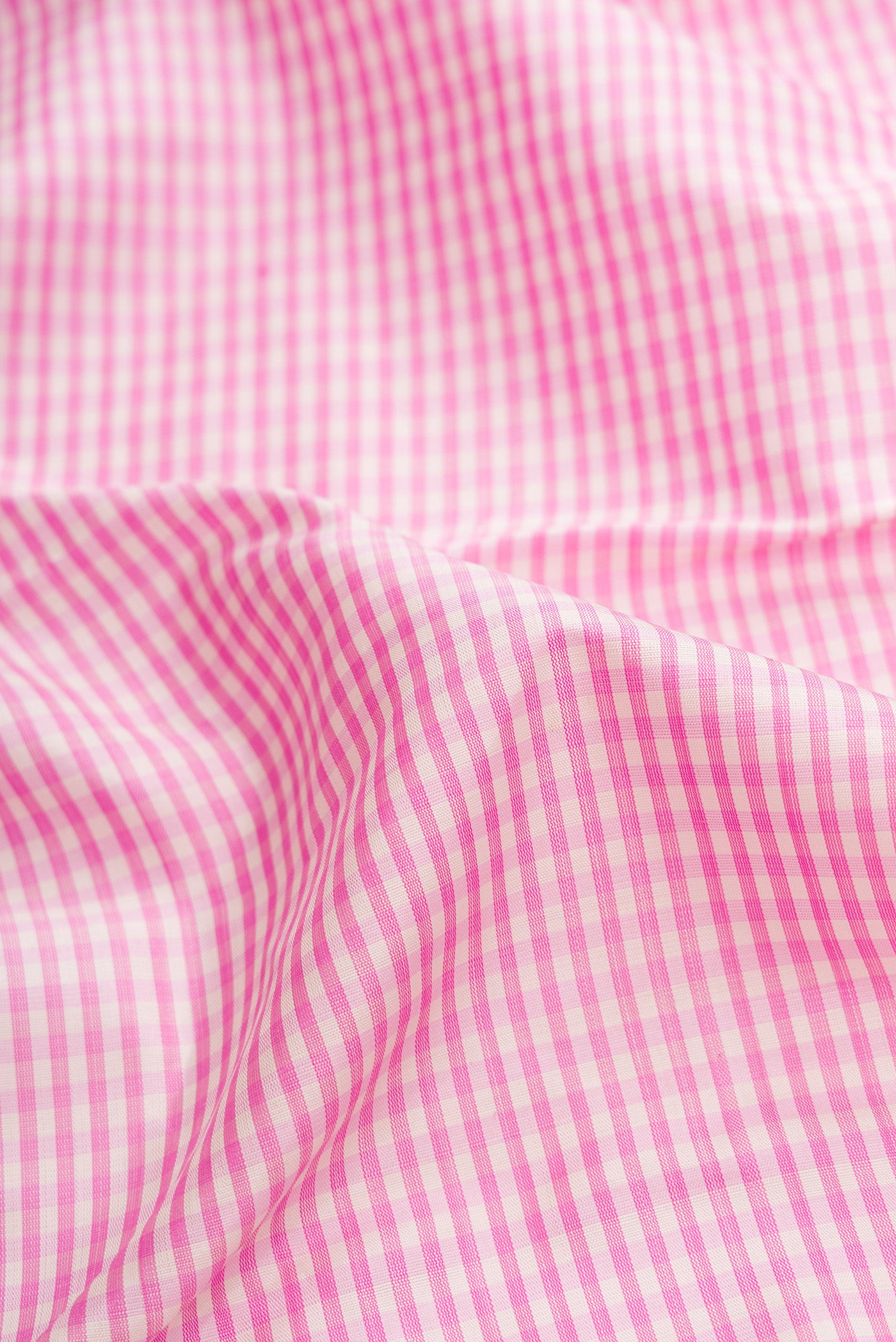 Close up of Pink Dual Tone Kanjivaram Silk Saree with Checked design on the body and Zari Border.  displaying folds