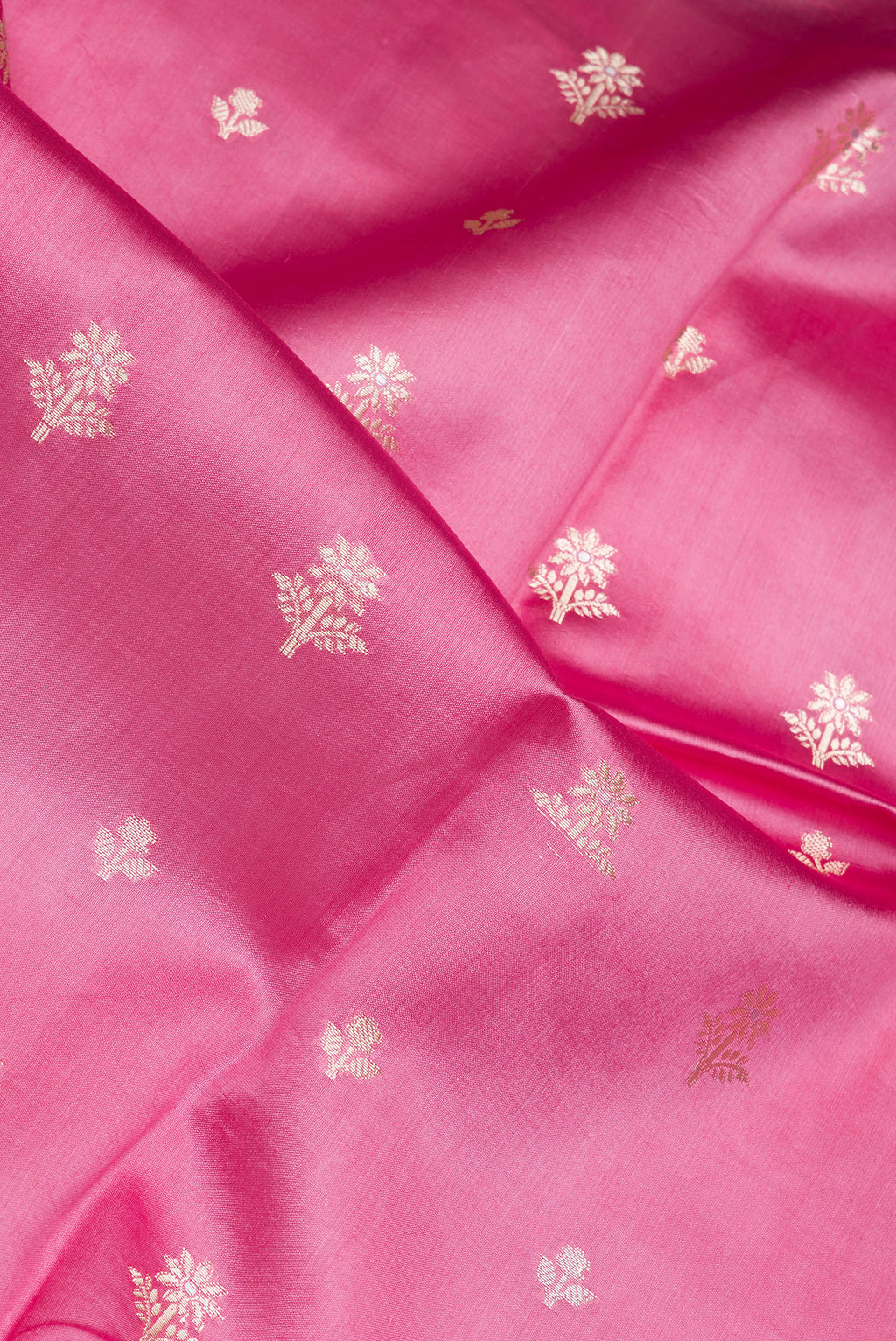 Close up of Pink Dual Tone Tussar Silk Saree with Zari Butta on the body and Fancy Border.  displaying folds