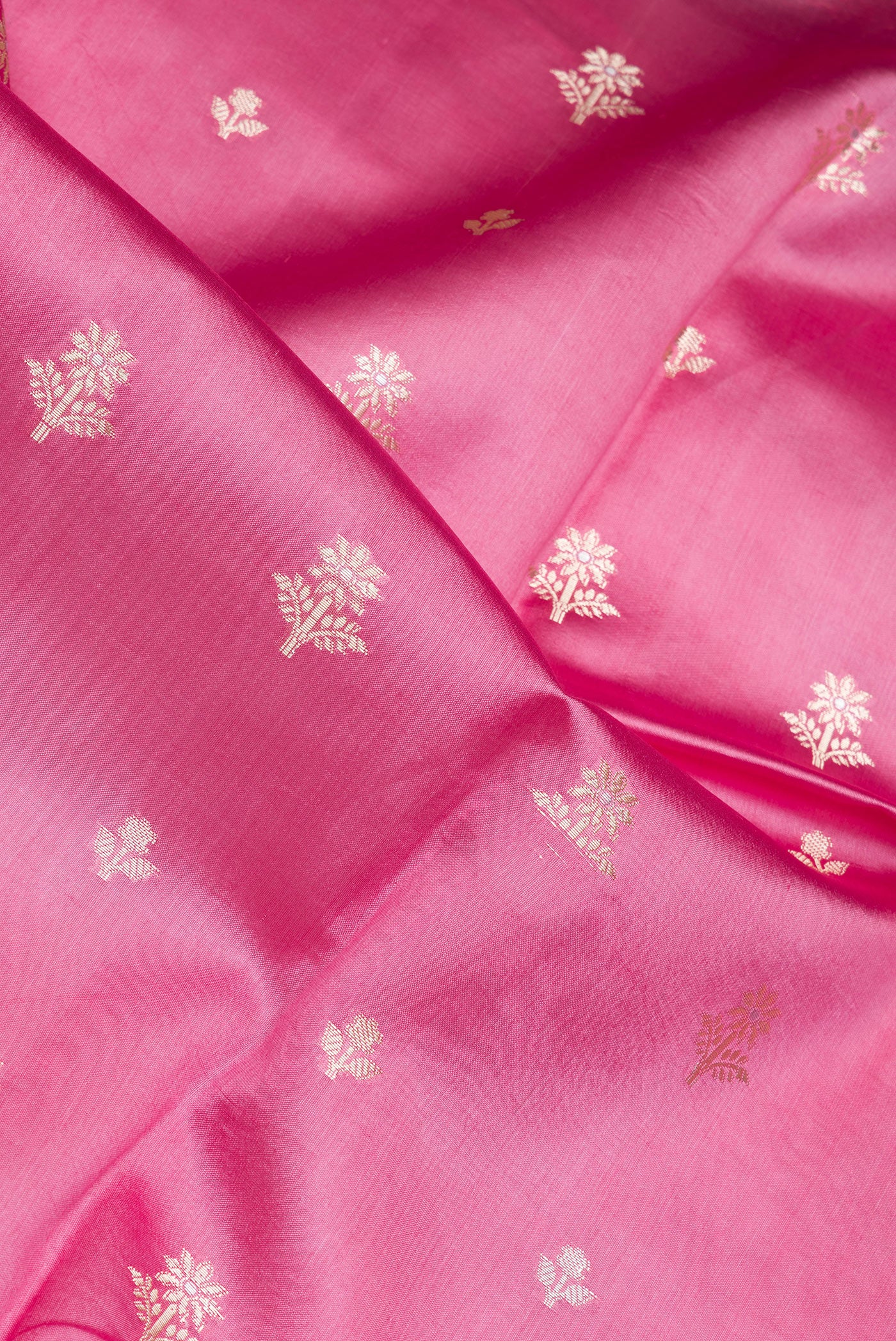 Close up of Pink Dual Tone Tussar Silk Saree with Zari Butta on the body and Fancy Border.  displaying folds