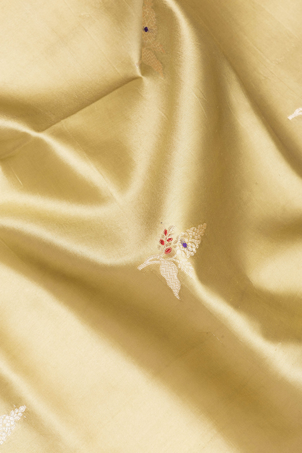 Close up of Pure Silk Green Dual Tone Tussar Saree with Zari Butta on the body and Fancy Border.  displaying folds