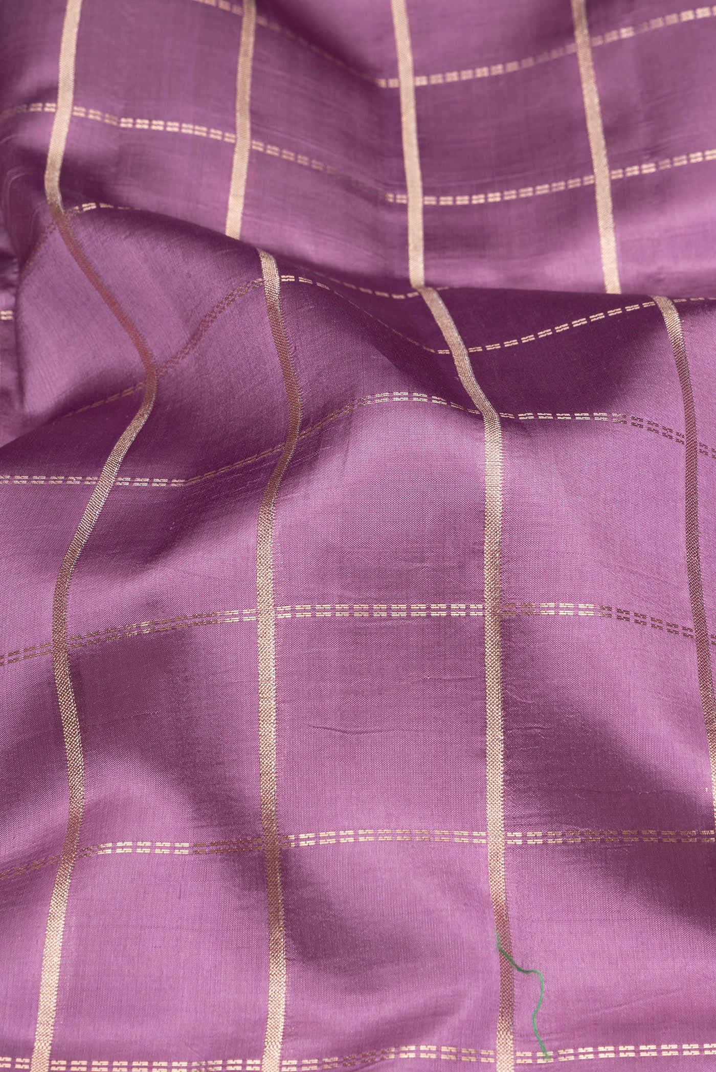 Close up of Purple Tussar Silk Saree with Checked design on the body and Fancy Border.  displaying folds