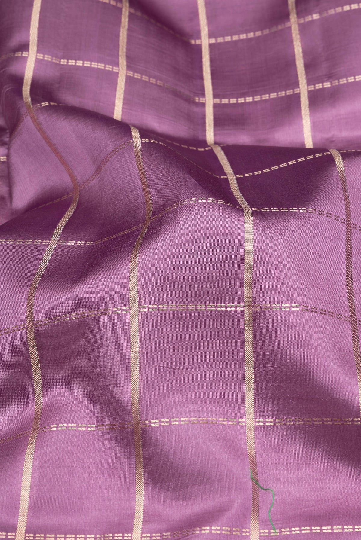 Close up of Purple Tussar Silk Saree with Checked design on the body and Fancy Border.  displaying folds