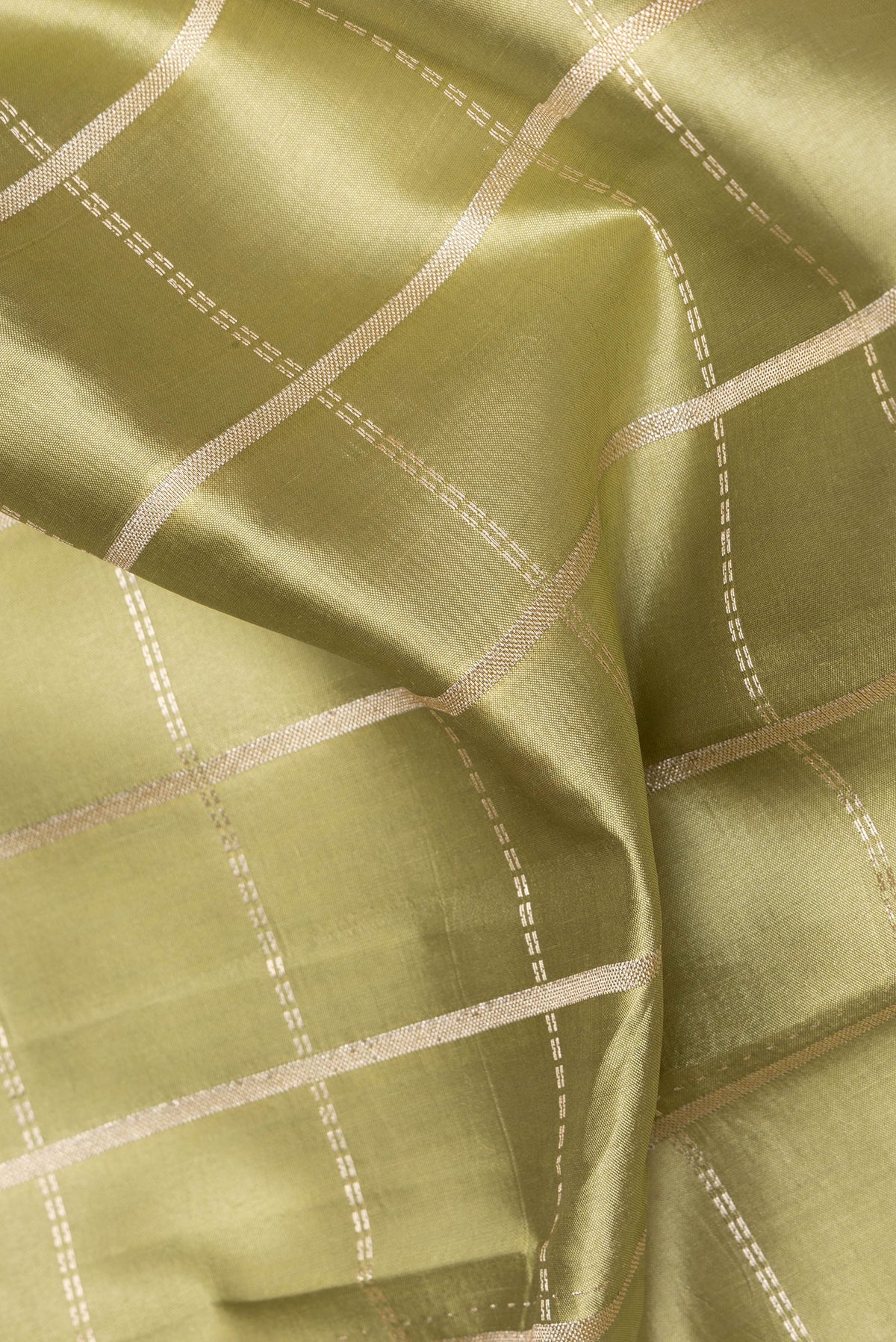 Close up of Pure Silk Pista Green Dual Tone Tussar Saree with Checked design on the body and Fancy Border.  displaying folds