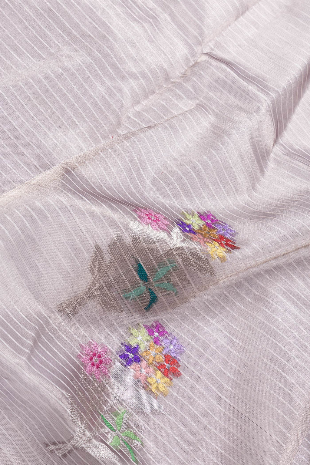 Close up of Purple Dual Tone Organza Silk Saree with Zari Brocade on the body and Zari Border.  displaying folds
