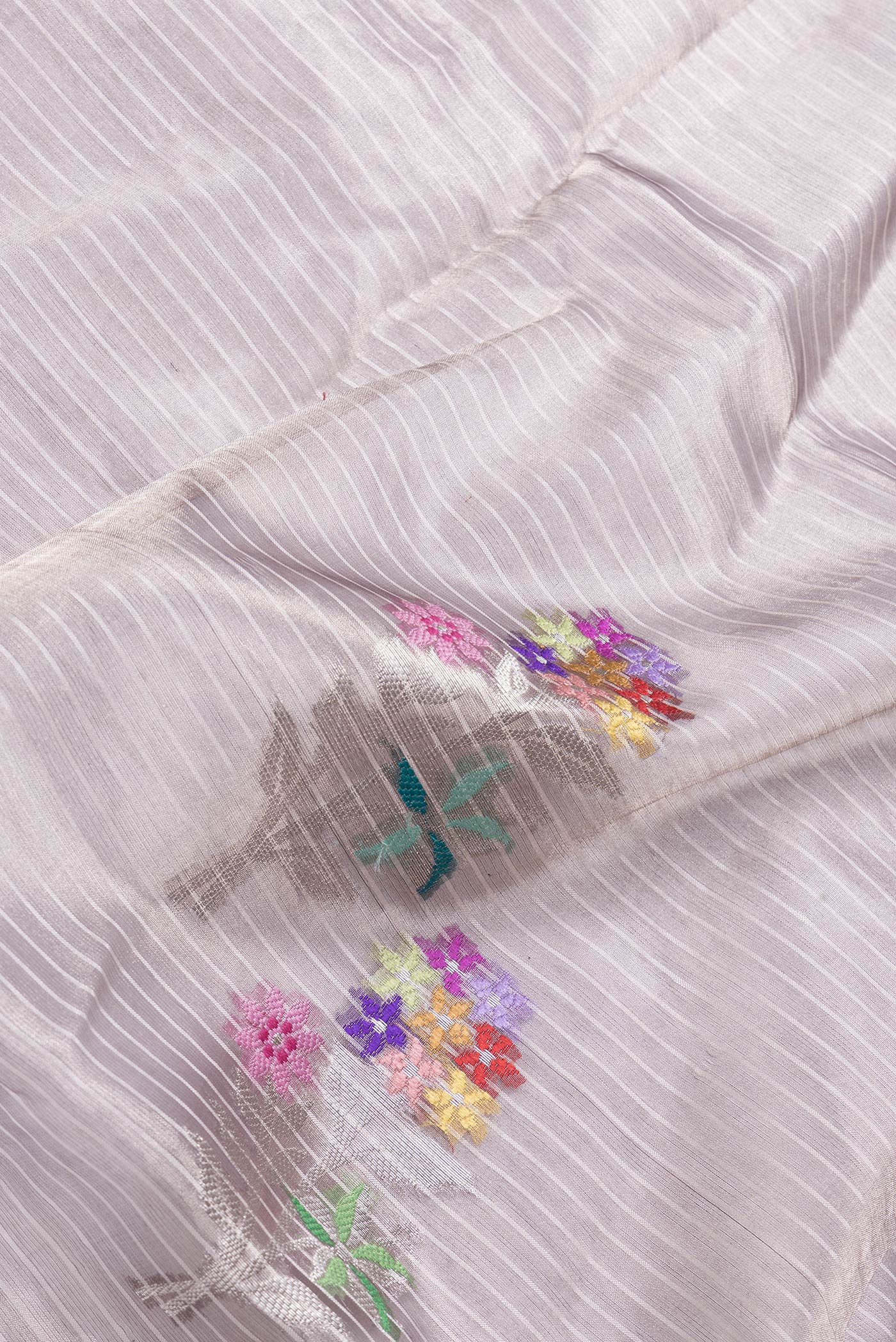 Close up of Purple Dual Tone Organza Silk Saree with Zari Brocade on the body and Zari Border.  displaying folds