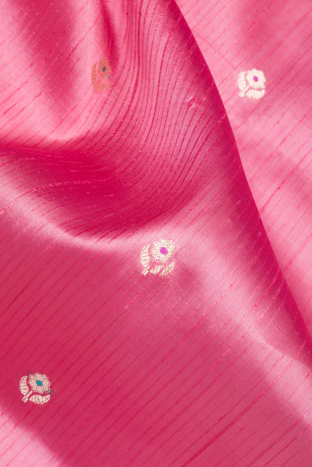 Close up of Pure Silk Pink Dual Tone Tussar Saree with Zari Butta on the body and Fancy Border.  displaying folds