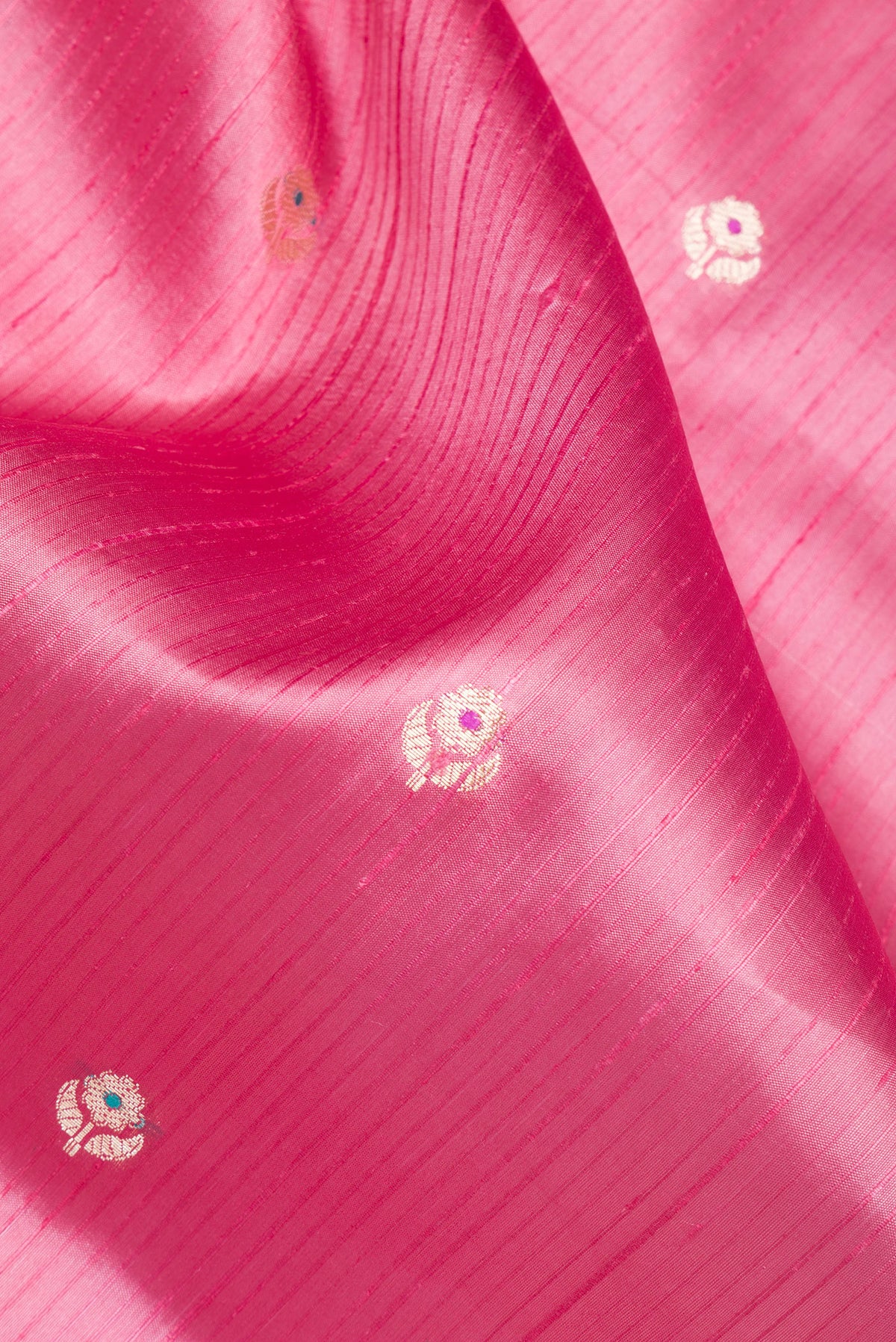 Close up of Pure Silk Pink Dual Tone Tussar Saree with Zari Butta on the body and Fancy Border.  displaying folds