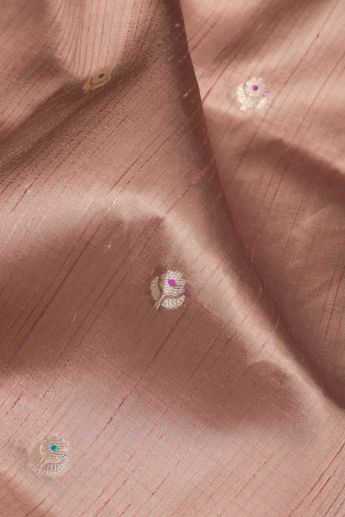 Close up of Brown Tussar Silk Saree with Zari Butta on the body and Fancy Border.  displaying folds