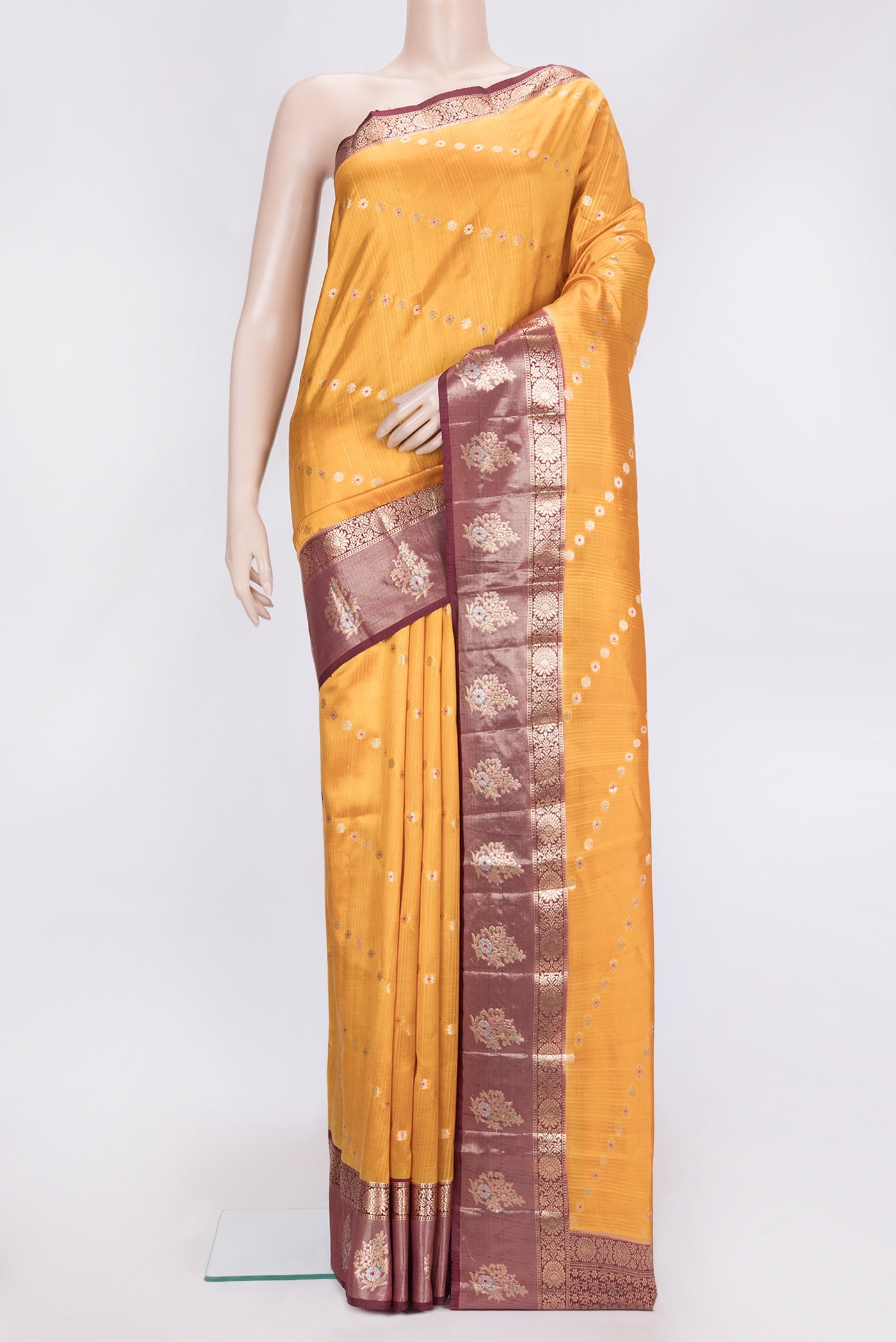 Mustard Dual Tone Tussar Silk Saree with Zari Butta on the body and Fancy Border.  displayed on a mannequin