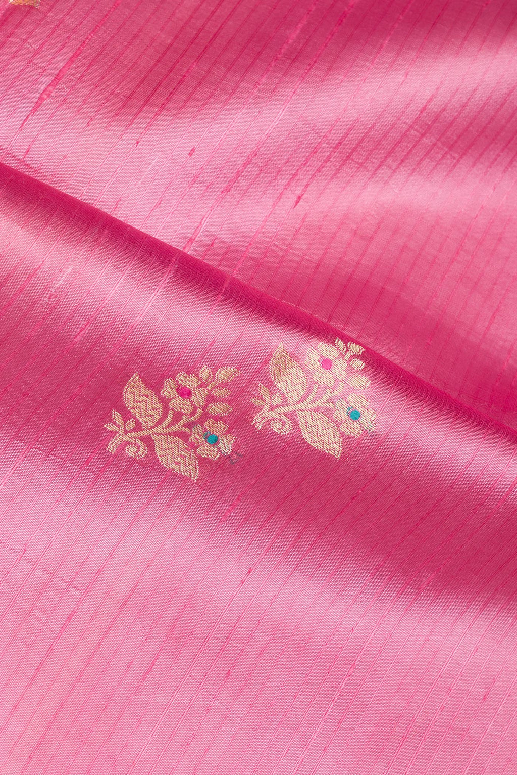 Close up of Pure Silk Rose pink Dual Tone Tussar Saree with Zari Butta on the body and Fancy Border.  displaying folds