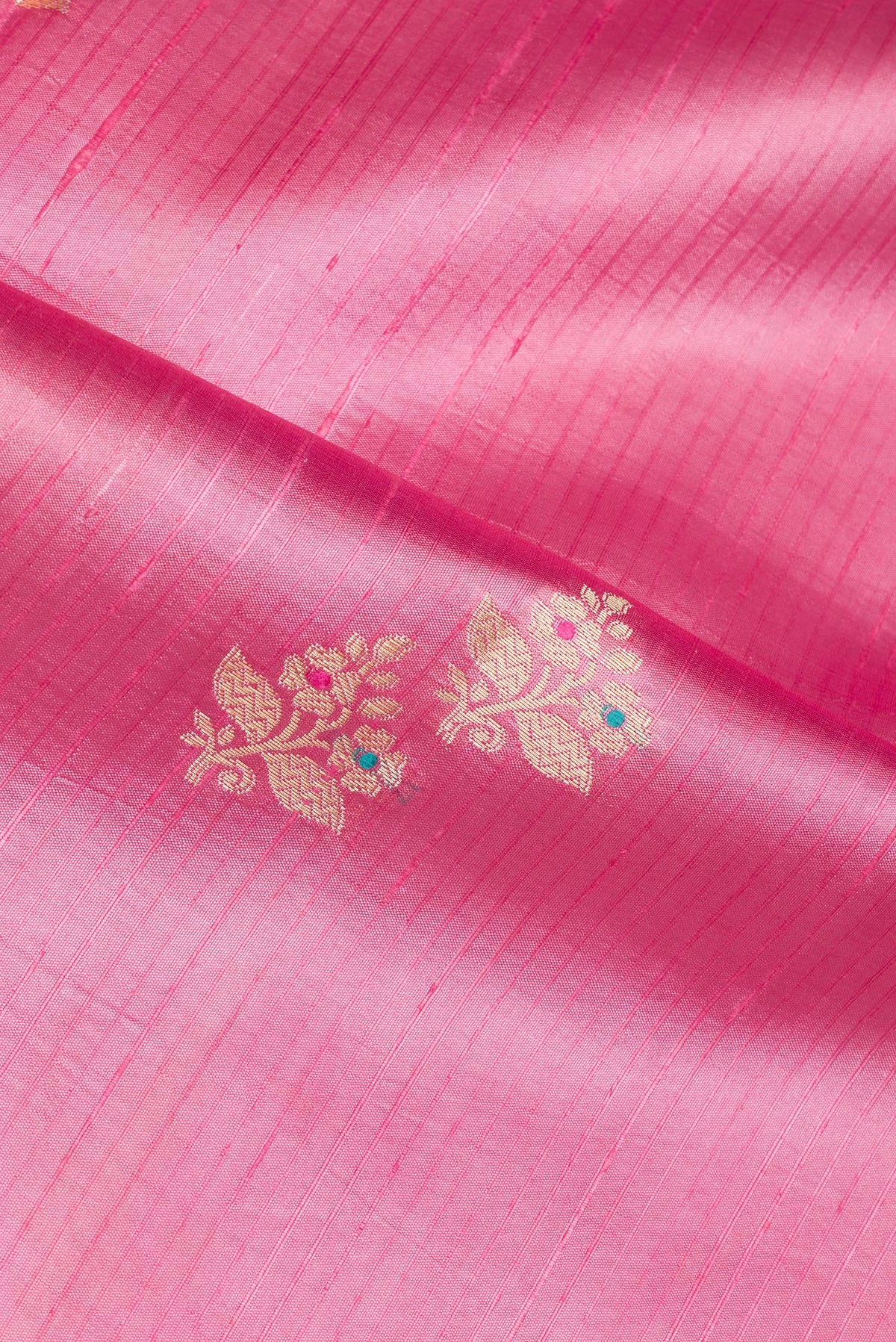 Close up of Pure Silk Rose pink Dual Tone Tussar Saree with Zari Butta on the body and Fancy Border.  displaying folds