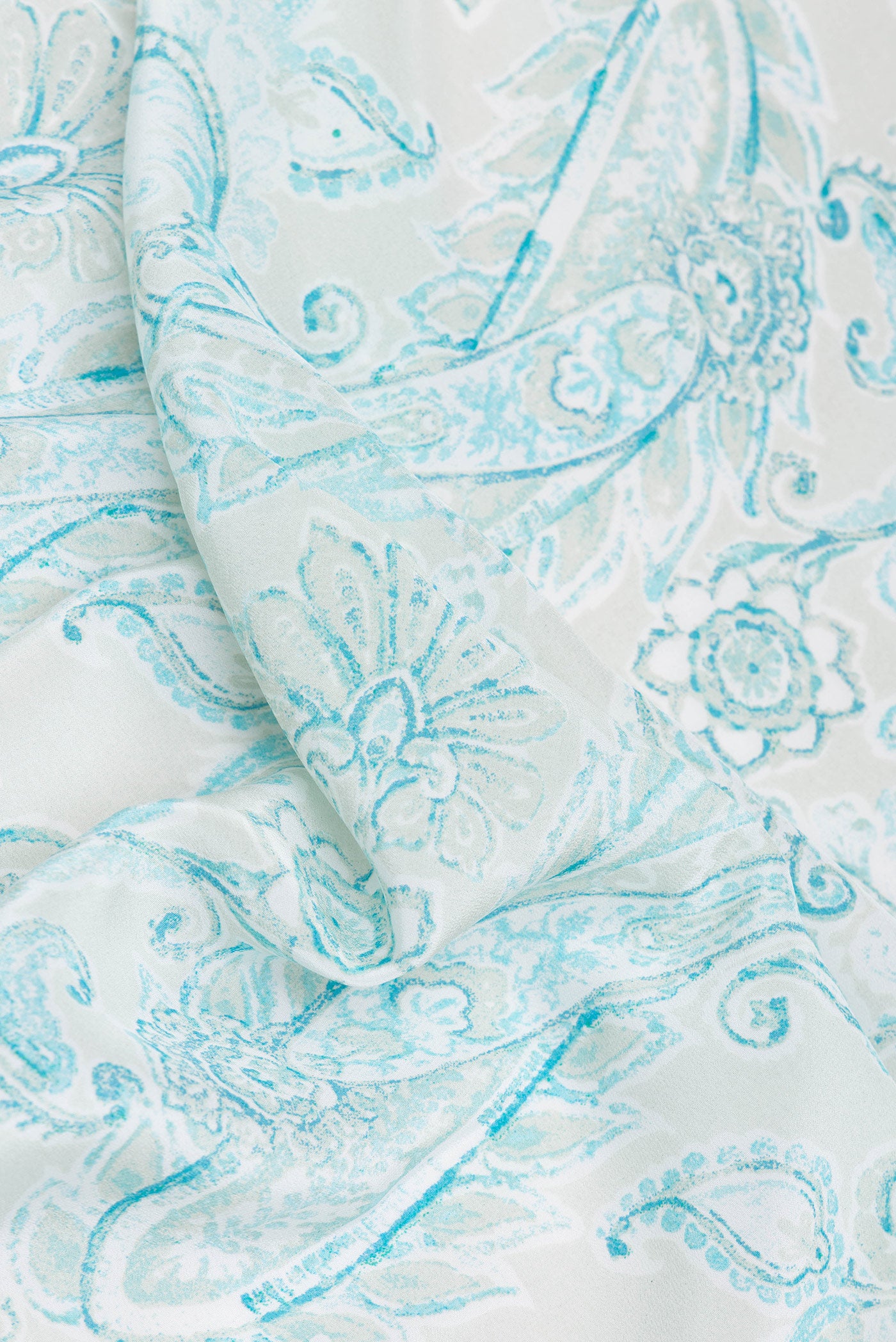 Close up of Pista Green Dual Tone Crepe Saree with Printed design on the body and Plain Border.  displaying folds