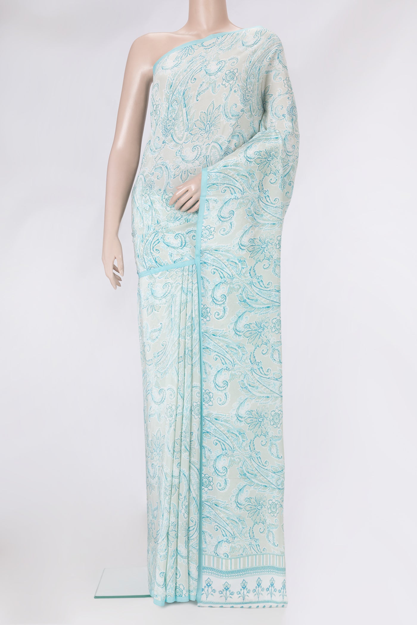Pista Green Dual Tone Crepe Saree with Printed design on the body and Plain Border.  displayed on a mannequin