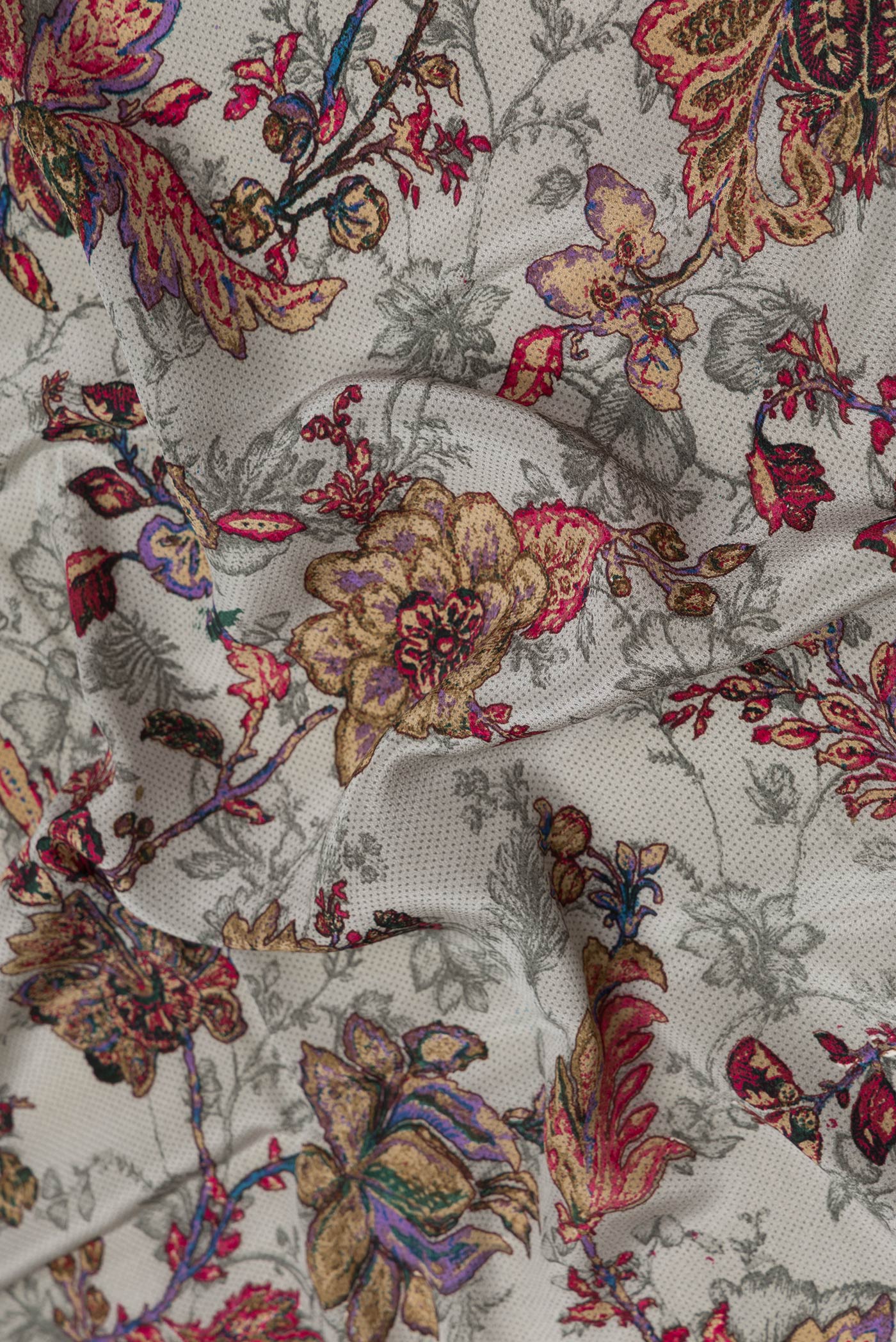 Close up of Grey Dual Tone Mysore Crepe Saree with Printed design on the body and Plain Border.  displaying folds