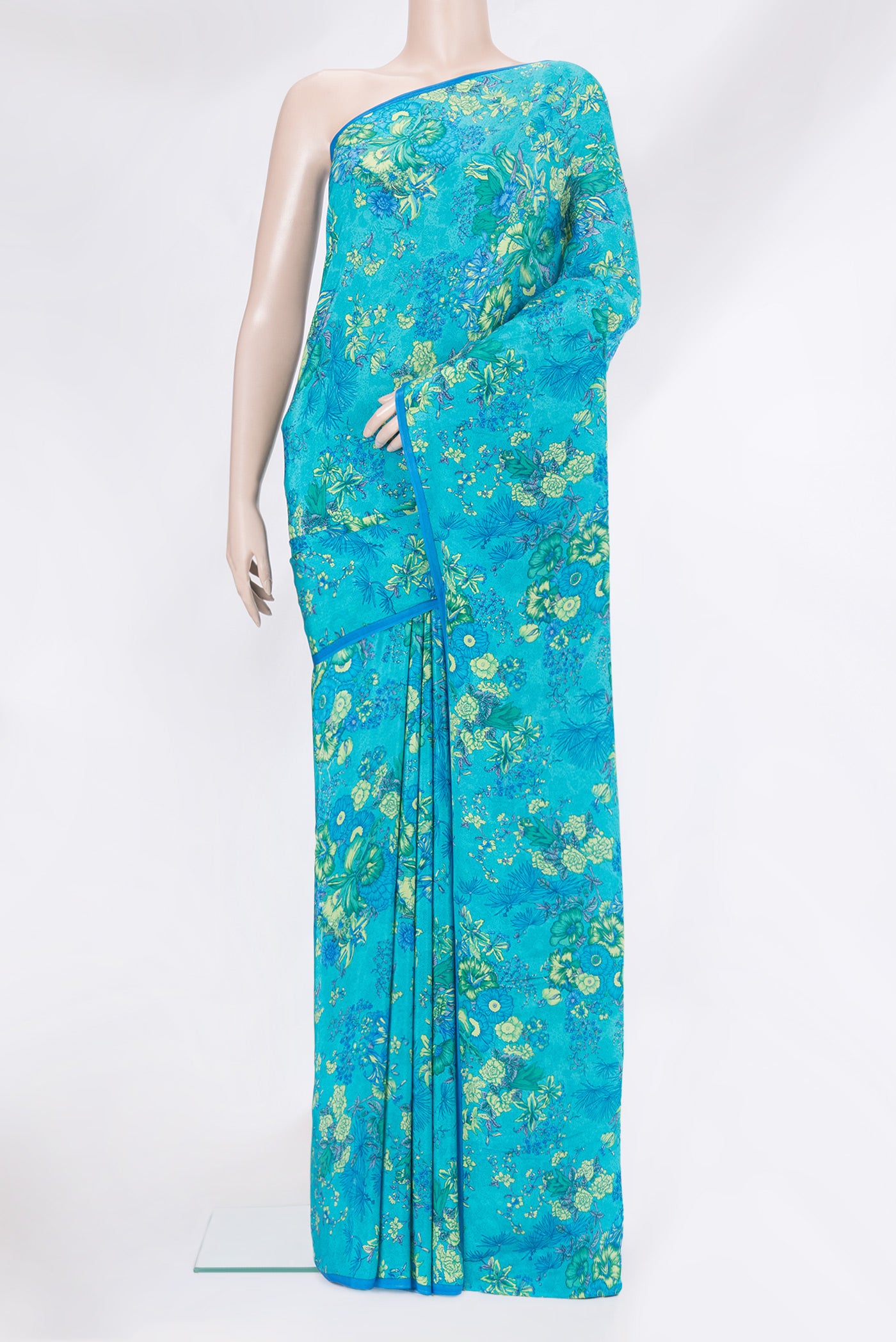 Sky Blue Crepe Saree with Printed design on the body and Plain Border.  displayed on a mannequin