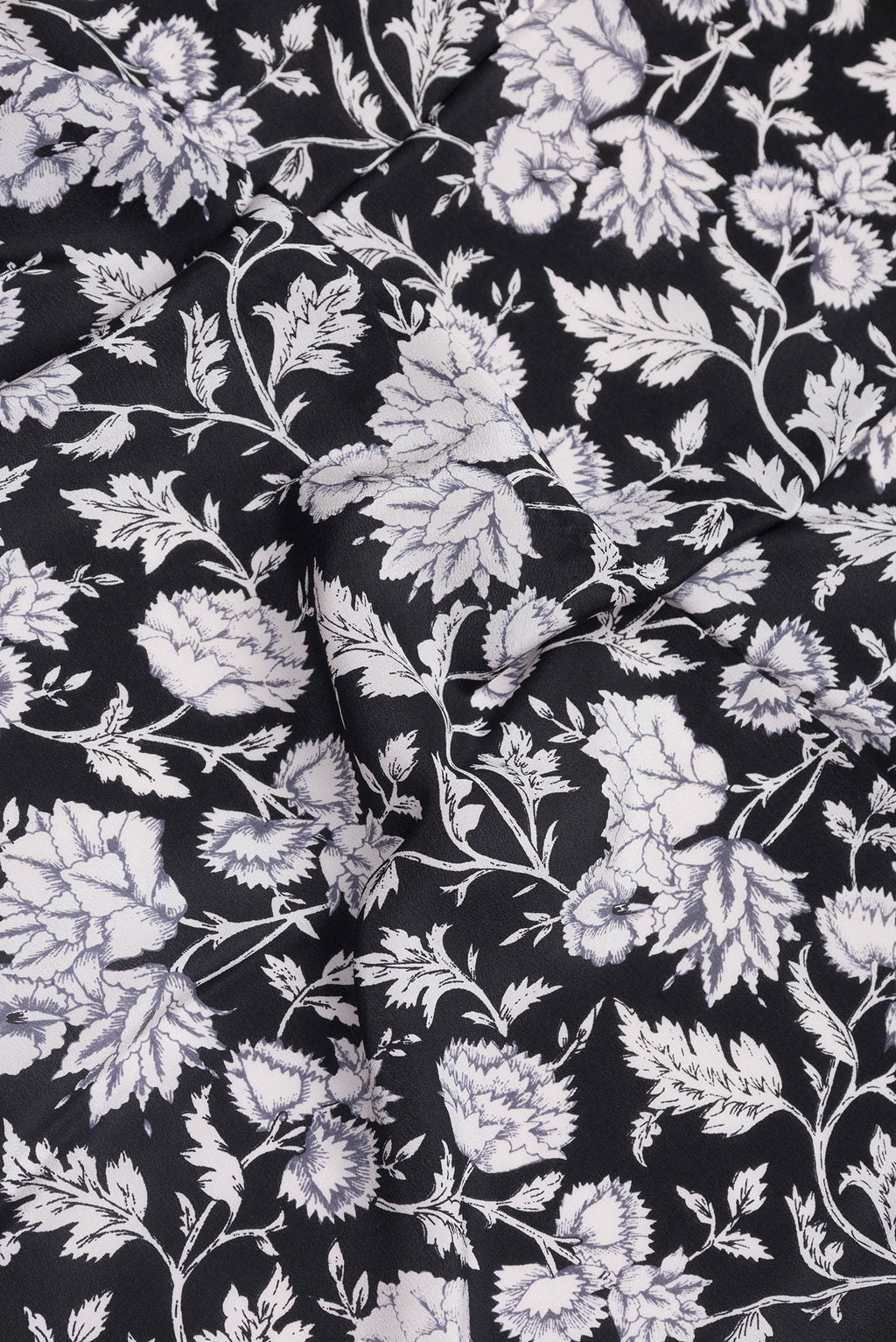 Close up of Black Dual Tone Crepe Saree with Printed design on the body and Printed Border.  displaying folds