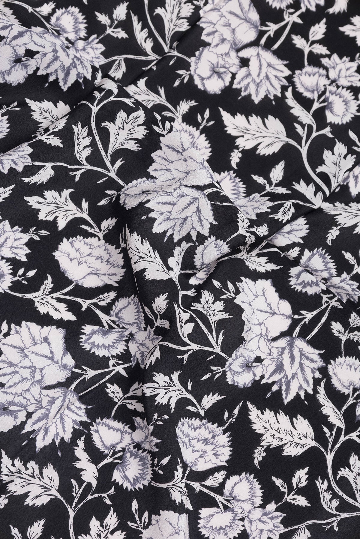 Close up of Black Dual Tone Crepe Saree with Printed design on the body and Printed Border.  displaying folds