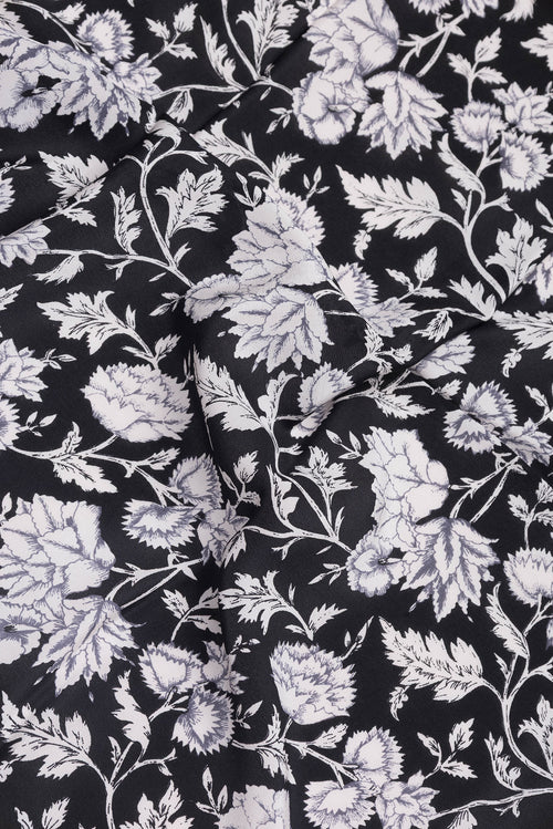 Close up of Black Dual Tone Crepe Saree with Printed design on the body and Printed Border.  displaying folds