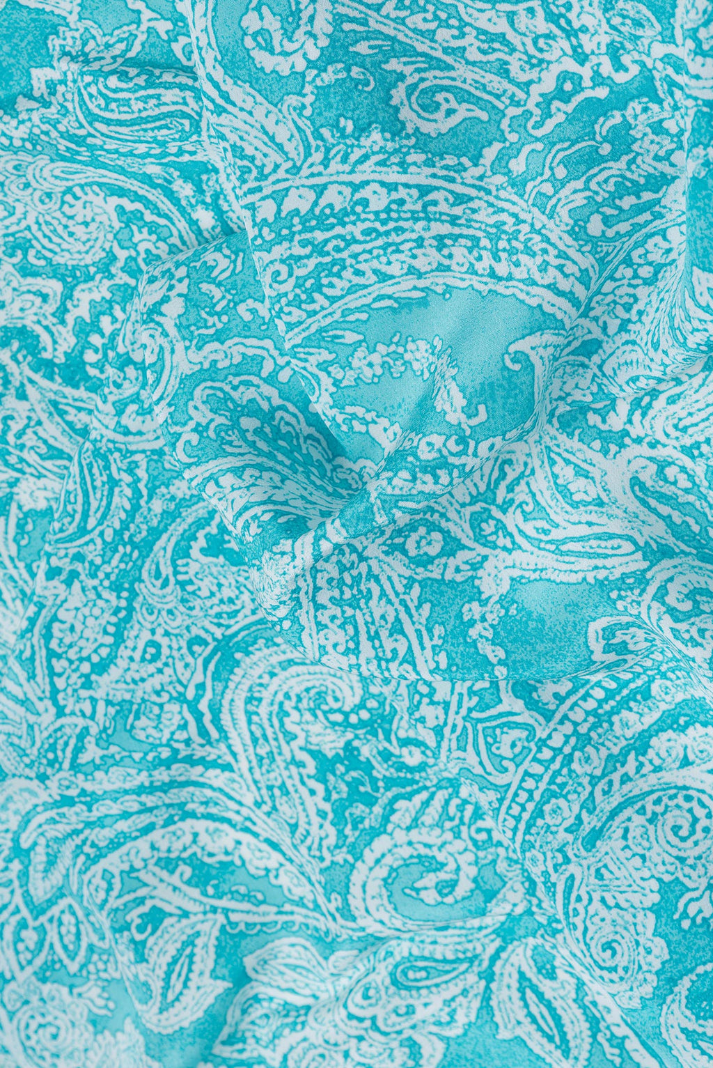 Close up of Sky Blue Dual Tone Mysore Crepe Saree with Printed design on the body and Plain Border.  displaying folds