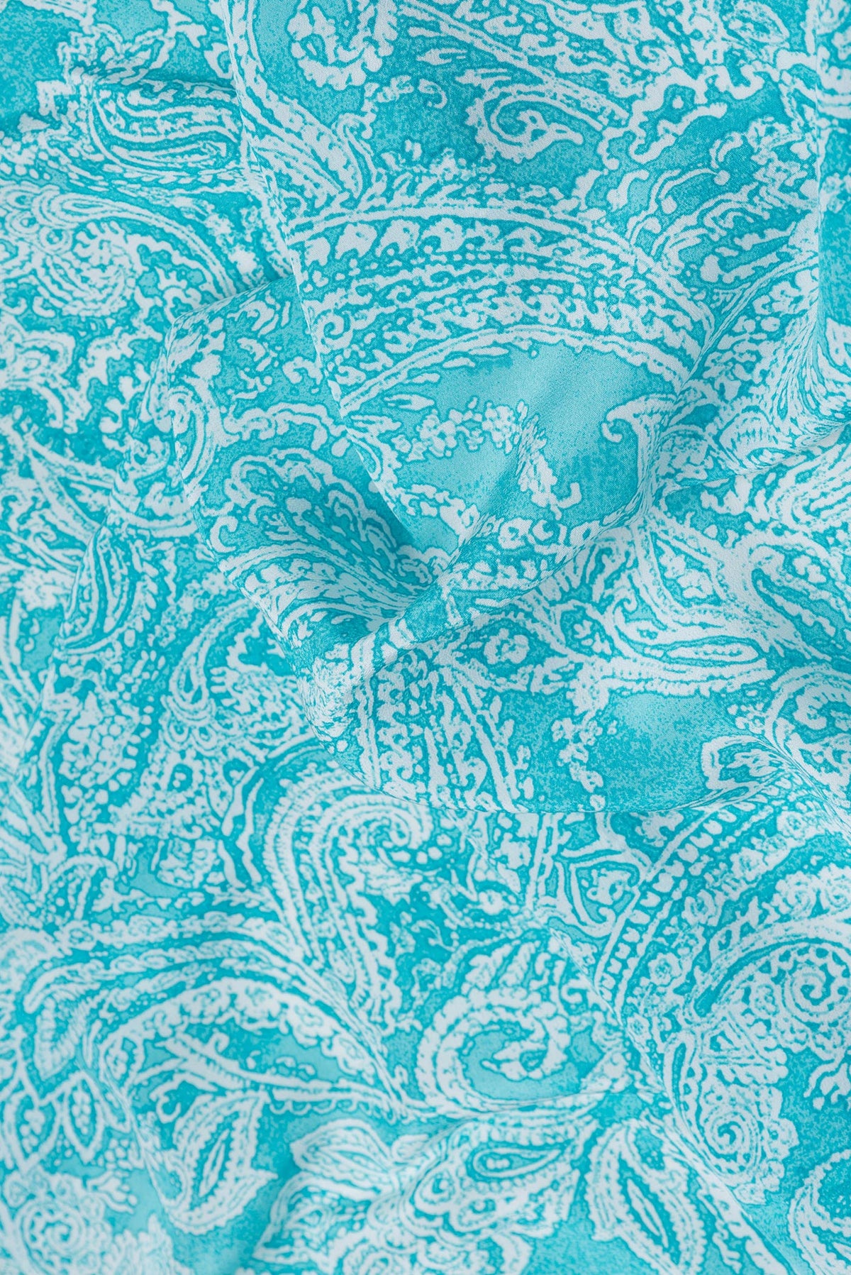 Close up of Sky Blue Dual Tone Mysore Crepe Saree with Printed design on the body and Plain Border.  displaying folds