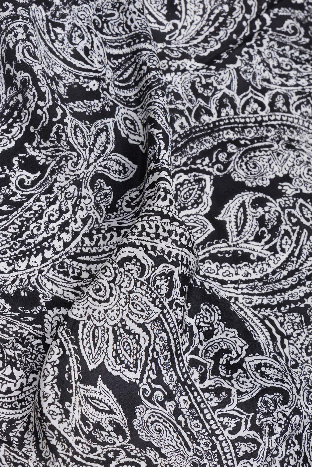 Close up of Black Crepe Saree with Printed design on the body and Printed Border.  displaying folds