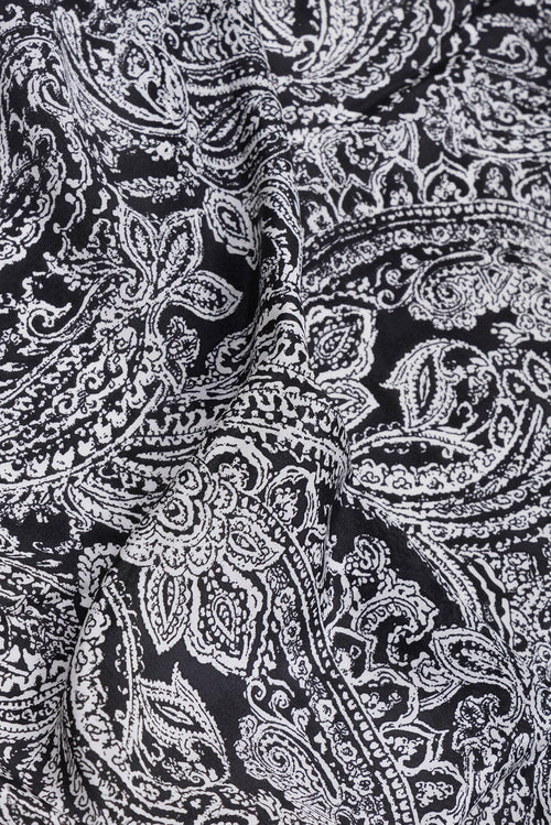 Close up of Black Crepe Saree with Printed design on the body and Printed Border.  displaying folds
