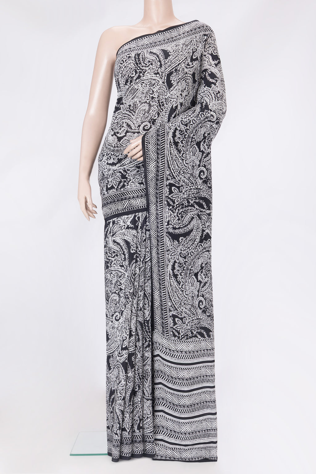 Black Crepe Saree with Printed design on the body and Printed Border.  displayed on a mannequin
