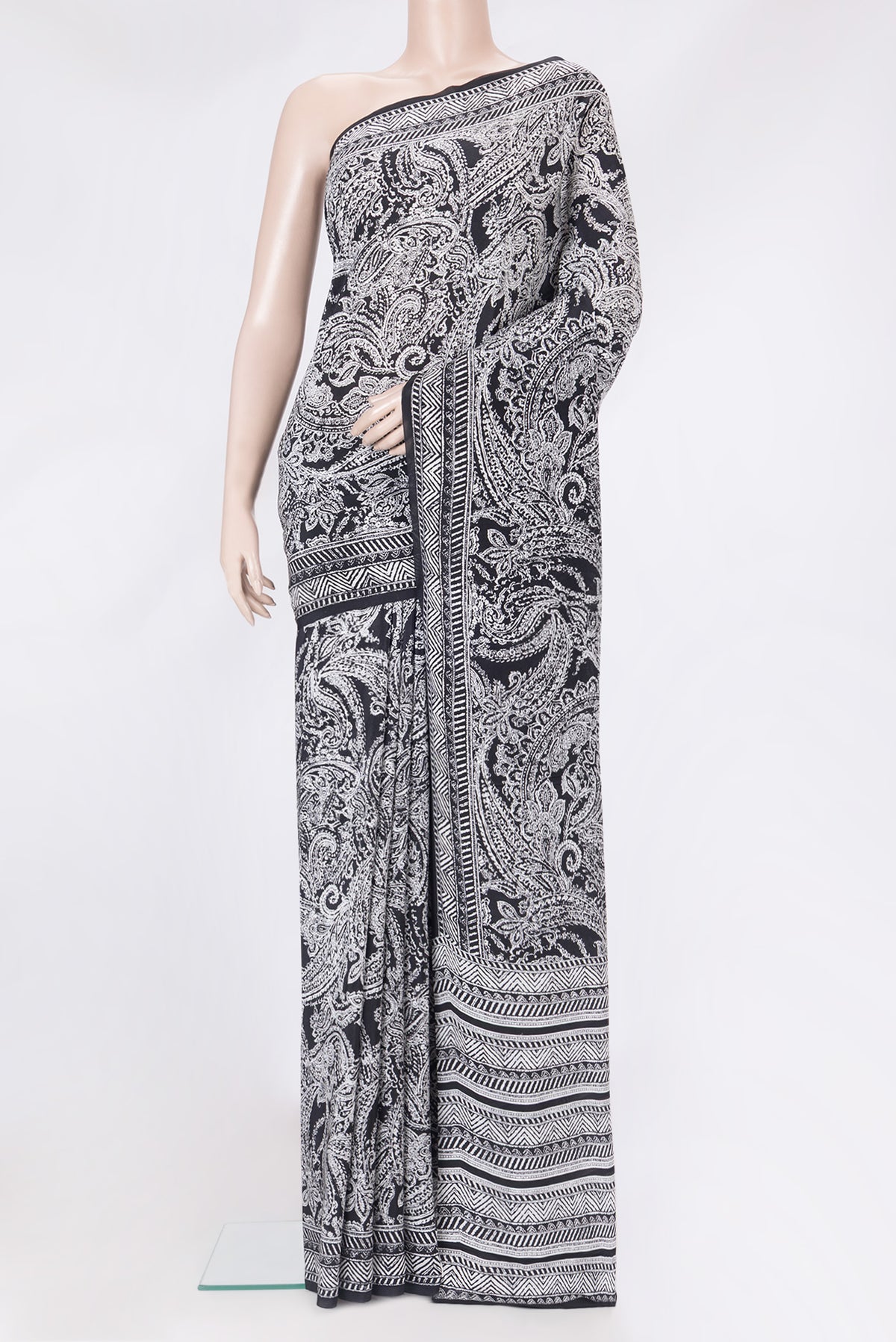 Black Crepe Saree with Printed design on the body and Printed Border.  displayed on a mannequin
