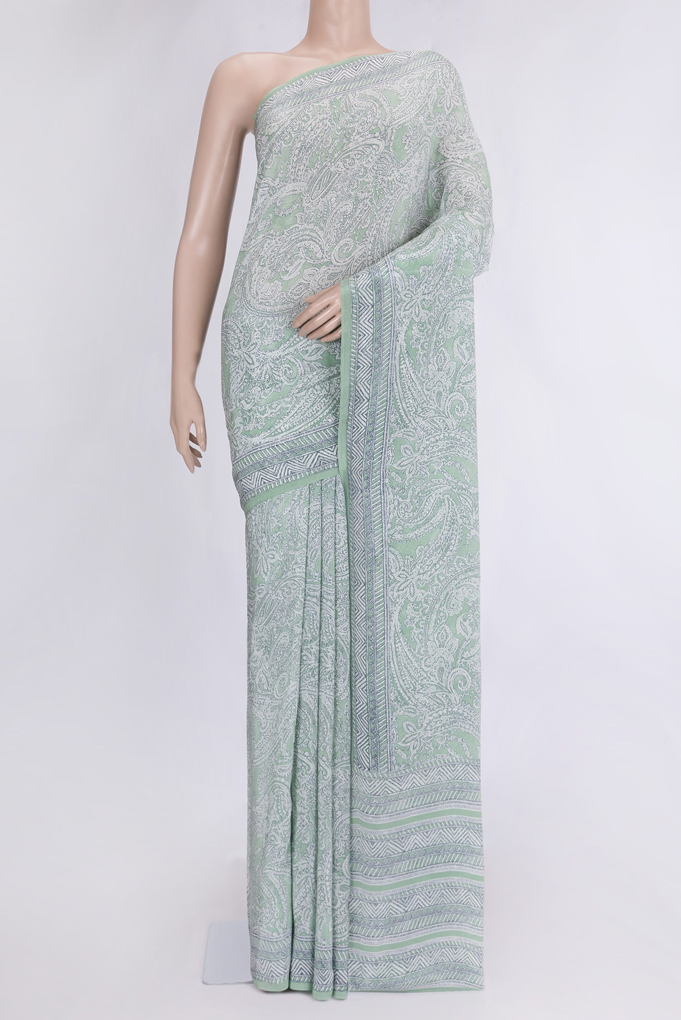 Pista Green Dual Tone Mysore Crepe Saree with Printed design on the body and Printed Border.  displayed on a mannequin