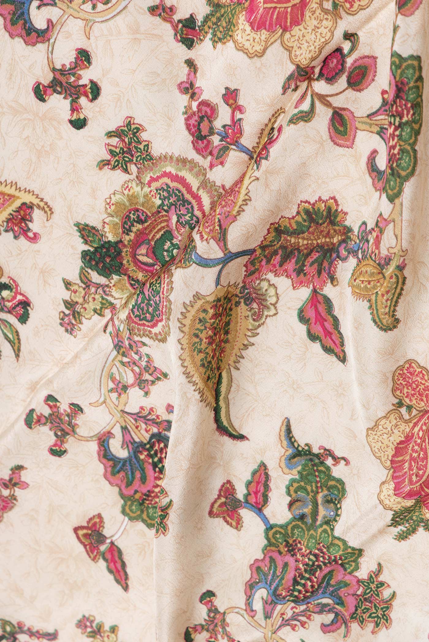 Close up of Beige Dual Tone Mysore Crepe Saree with Printed design on the body and Printed Border.  displaying folds