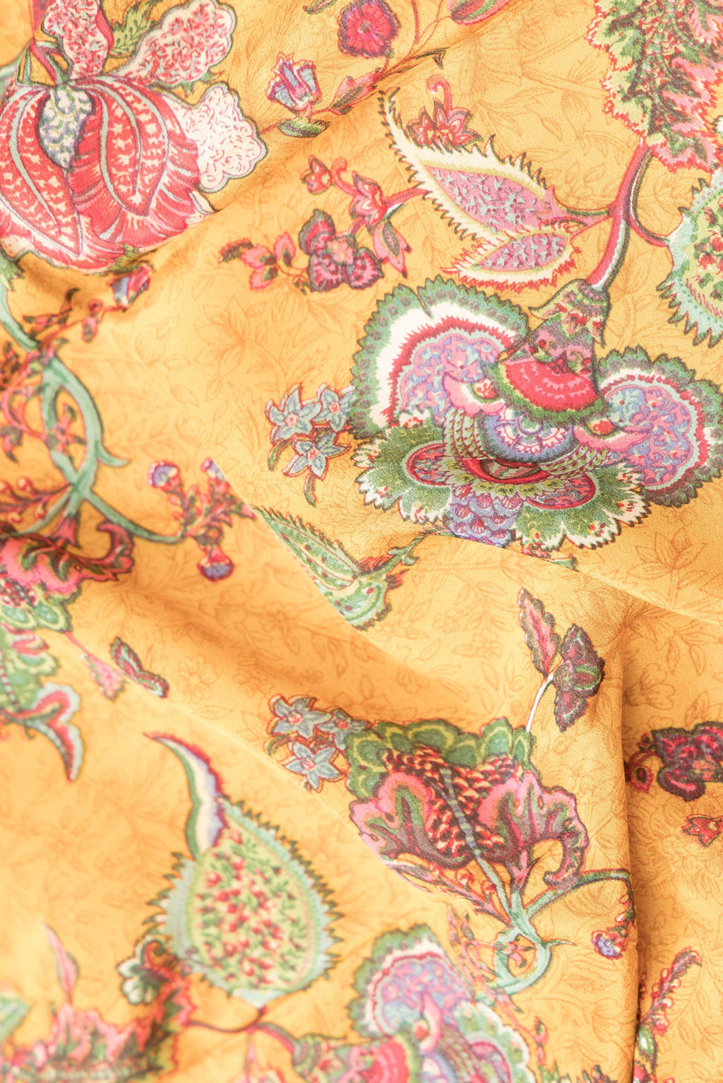 Close up of Mustard Dual Tone Mysore Crepe Saree with Printed design on the body and Printed Border.  displaying folds
