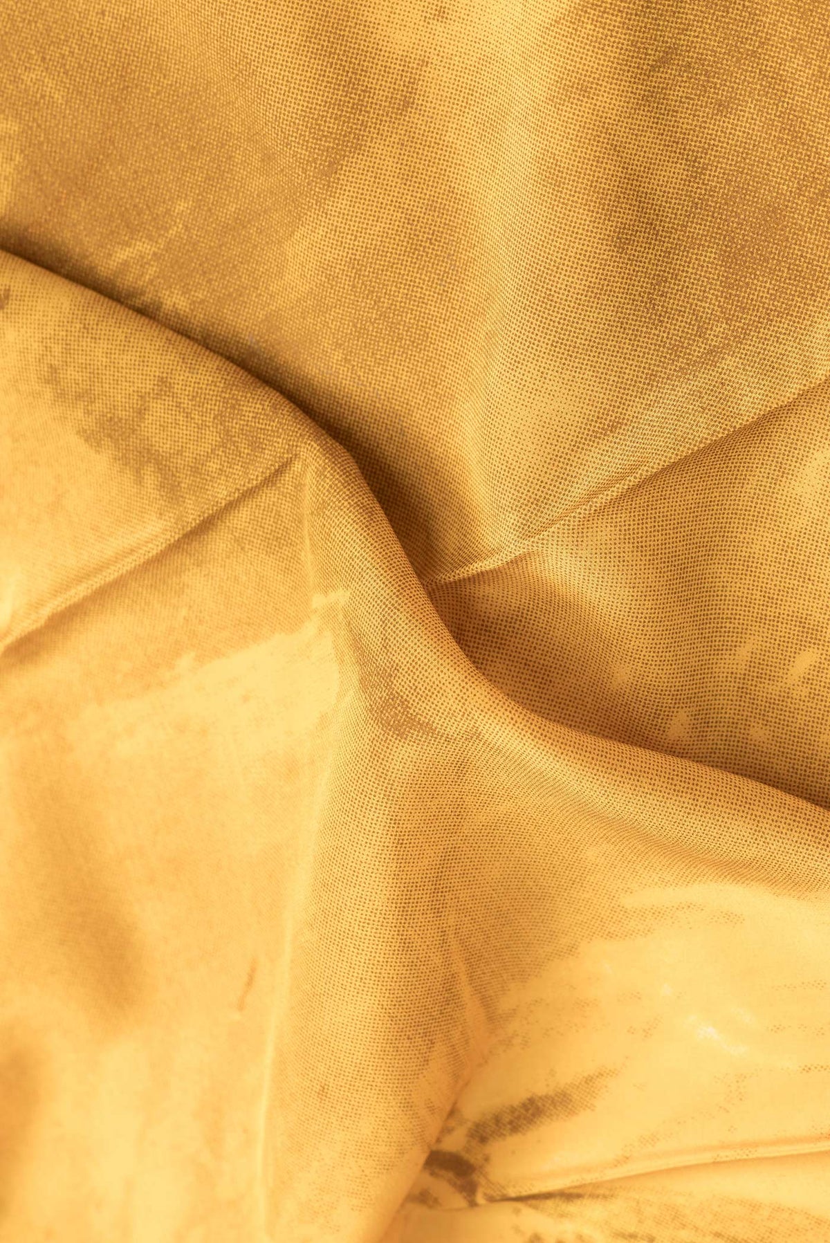 Close up of Mustard Dual Tone Mysore Crepe Saree with Printed design on the body and Plain Border.  displaying folds
