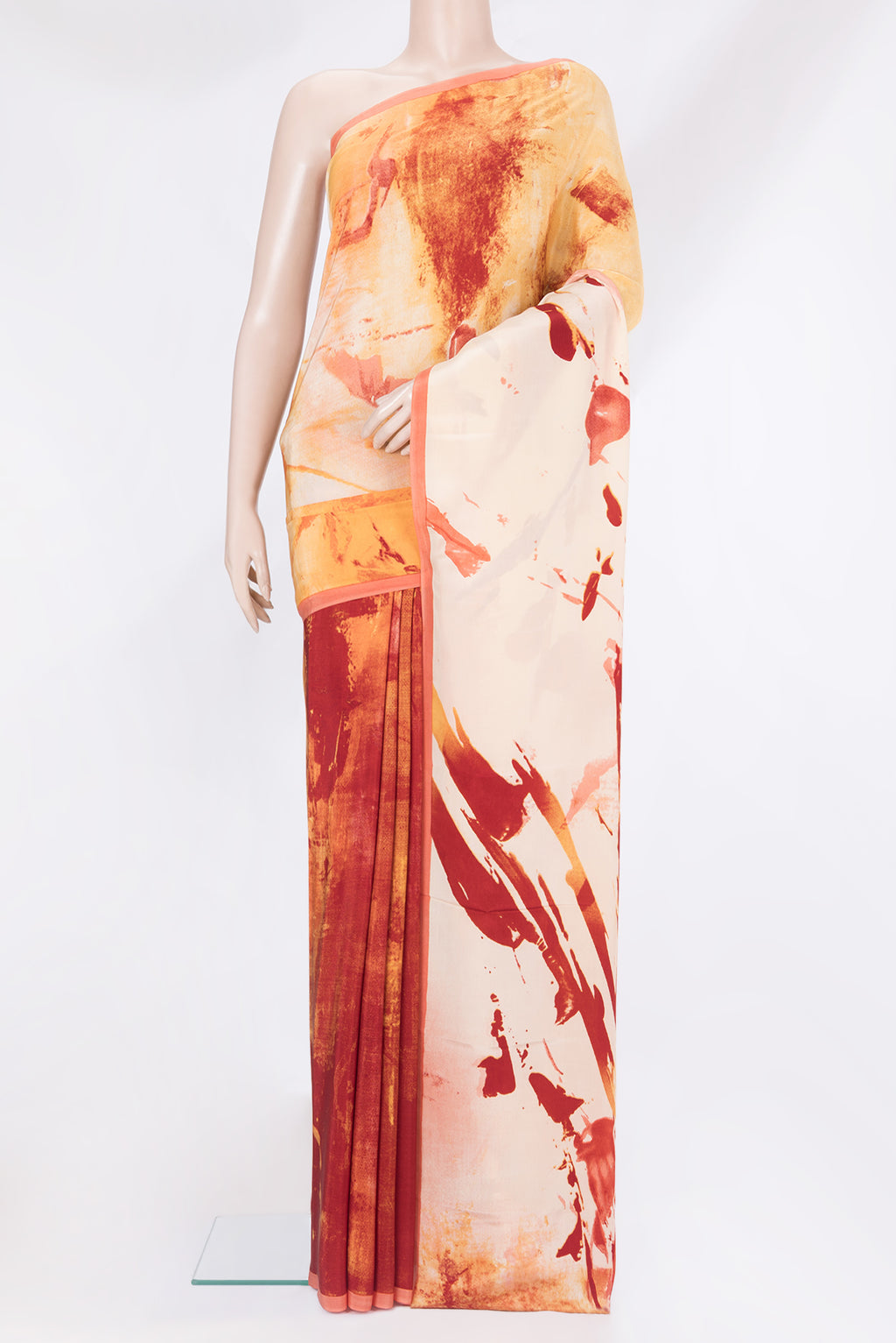 Rust Crepe Saree with Printed design on the body and Plain Border.  displayed on a mannequin