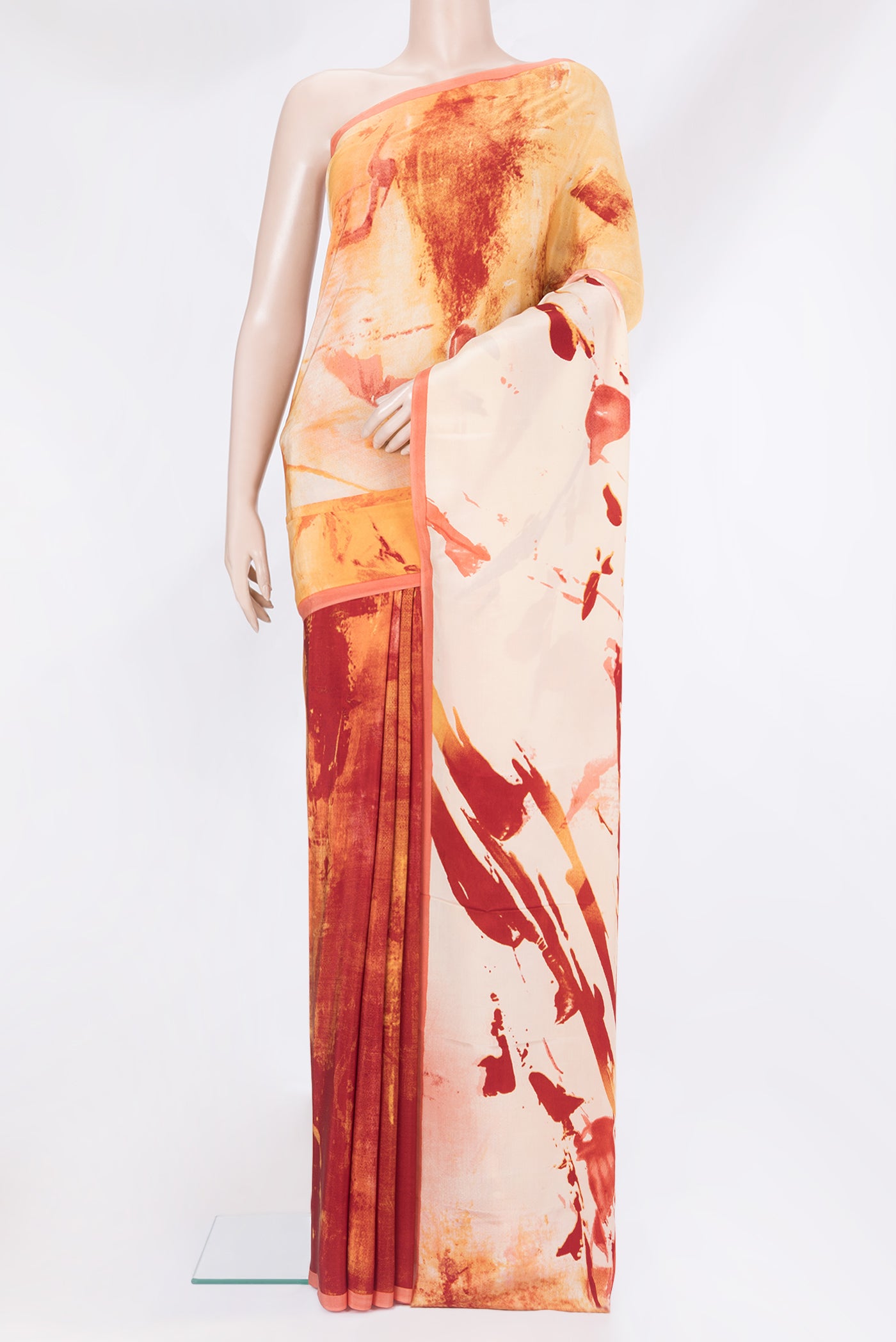 Rust Crepe Saree with Printed design on the body and Plain Border.  displayed on a mannequin