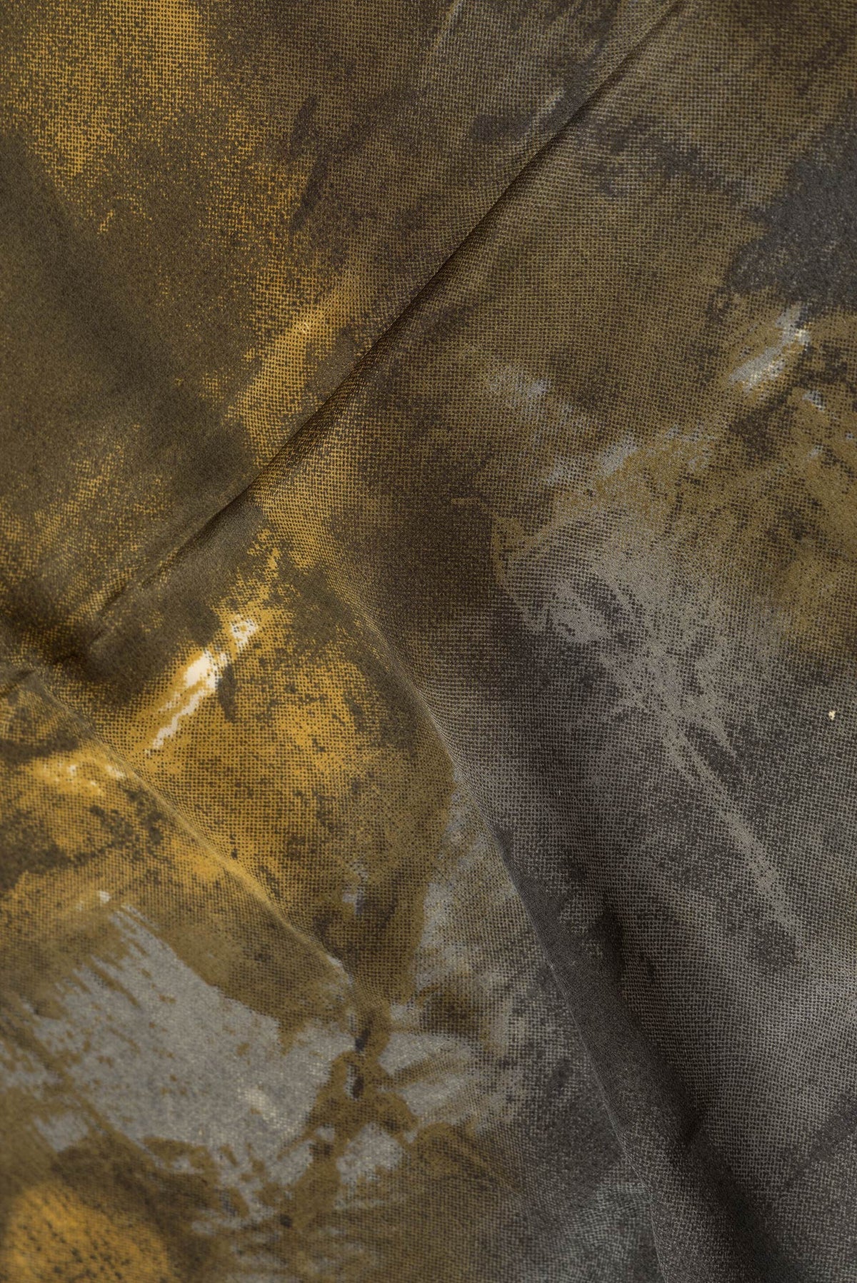 Close up of Grey Dual Tone Mysore Crepe Saree with Printed design on the body and Plain Border.  displaying folds