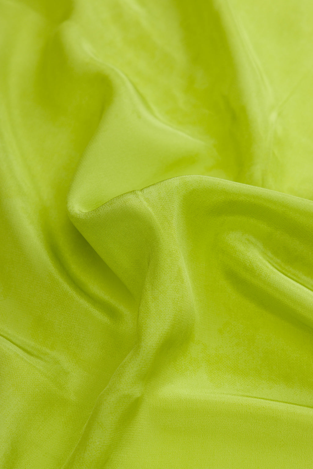 Close up of Parrot Green Dual Tone Mysore Crepe Saree with Printed design on the body and Plain Border.  displaying folds