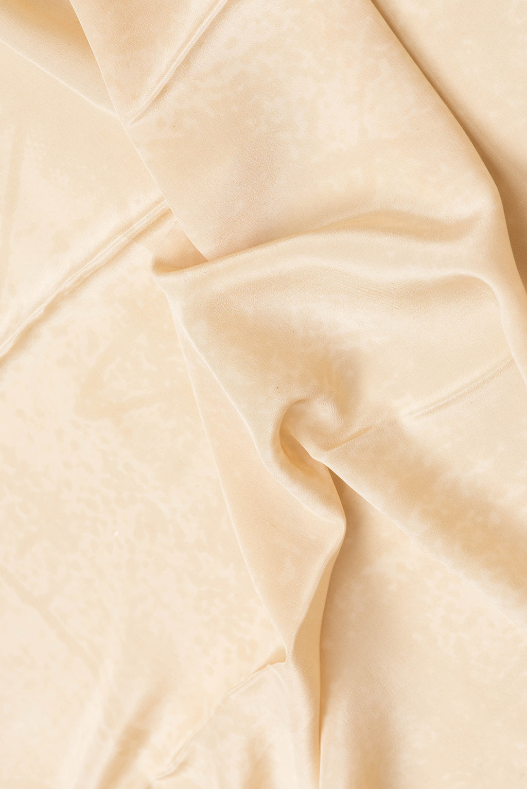 Close up of Sandal Dual Tone Mysore Crepe Saree with Printed design on the body and Plain Border.  displaying folds