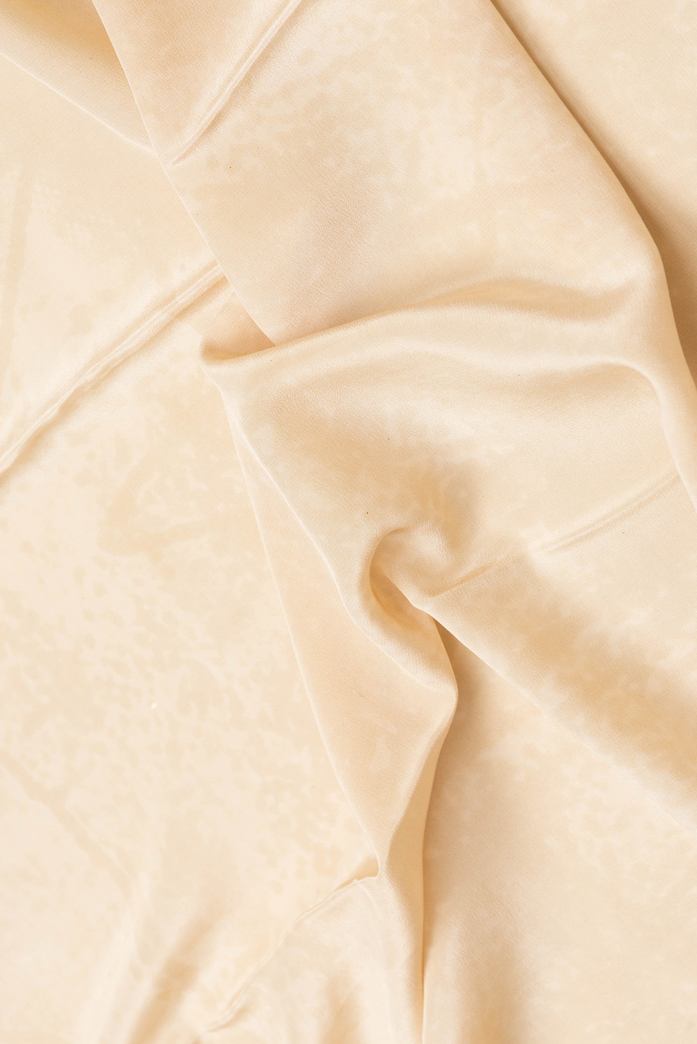 Close up of Sandal Dual Tone Mysore Crepe Saree with Printed design on the body and Plain Border.  displaying folds