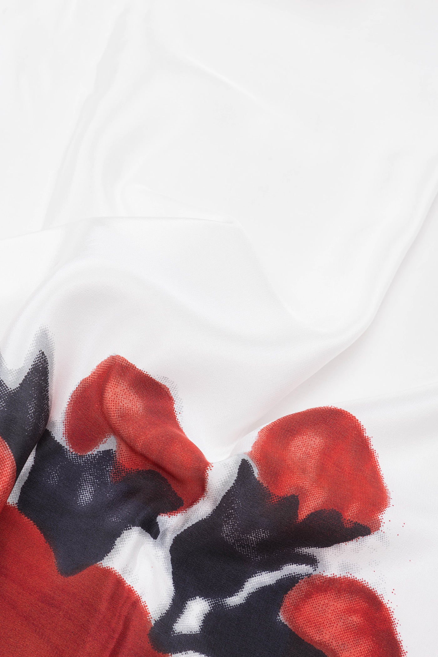 Close up of White Crepe Saree with Printed design on the body and Fancy Border.  displaying folds